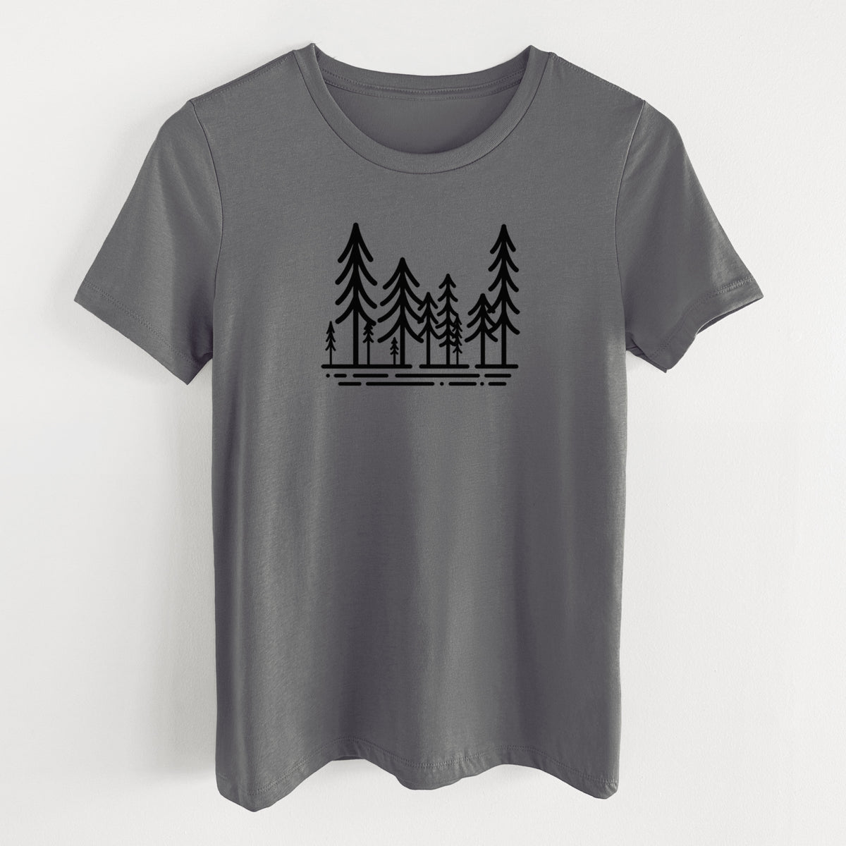 Asphalt women's relaxed fit cotton t-shirt laid flat, printed with bold black line art of ten simple pine trees above horizontal lines.