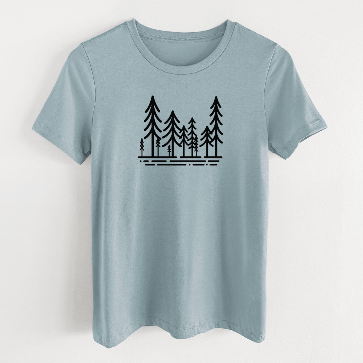 Vintage denim women's relaxed fit cotton t-shirt laid flat, printed with bold black line art of ten simple pine trees above horizontal lines.
