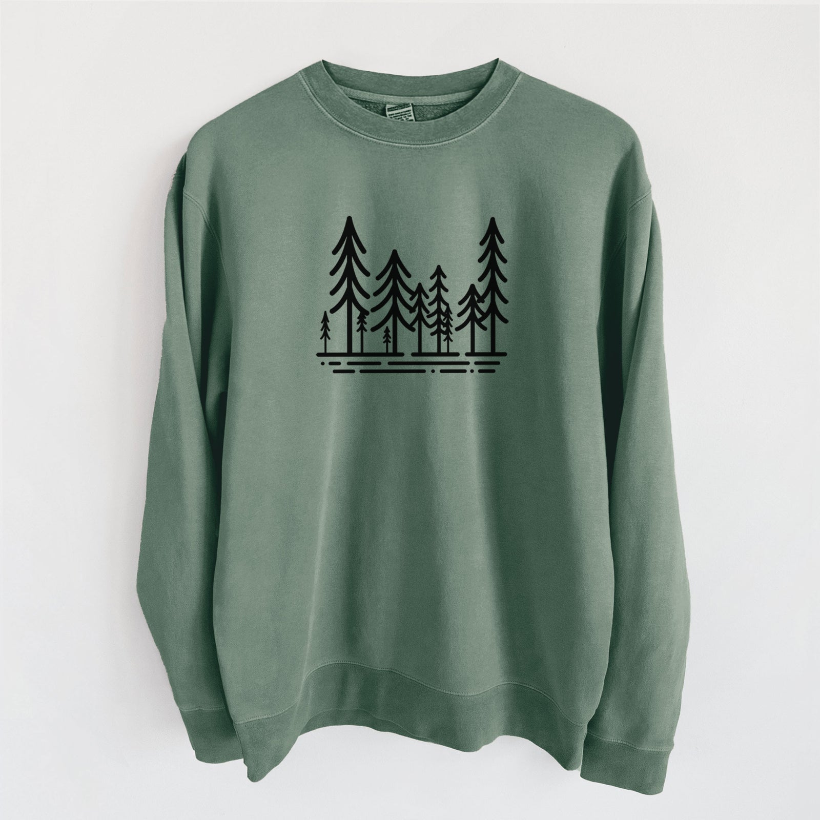 Alpine green pigment dyed crewneck sweatshirt laid flat, printed with bold black line art of ten simple pine trees above horizontal lines.
