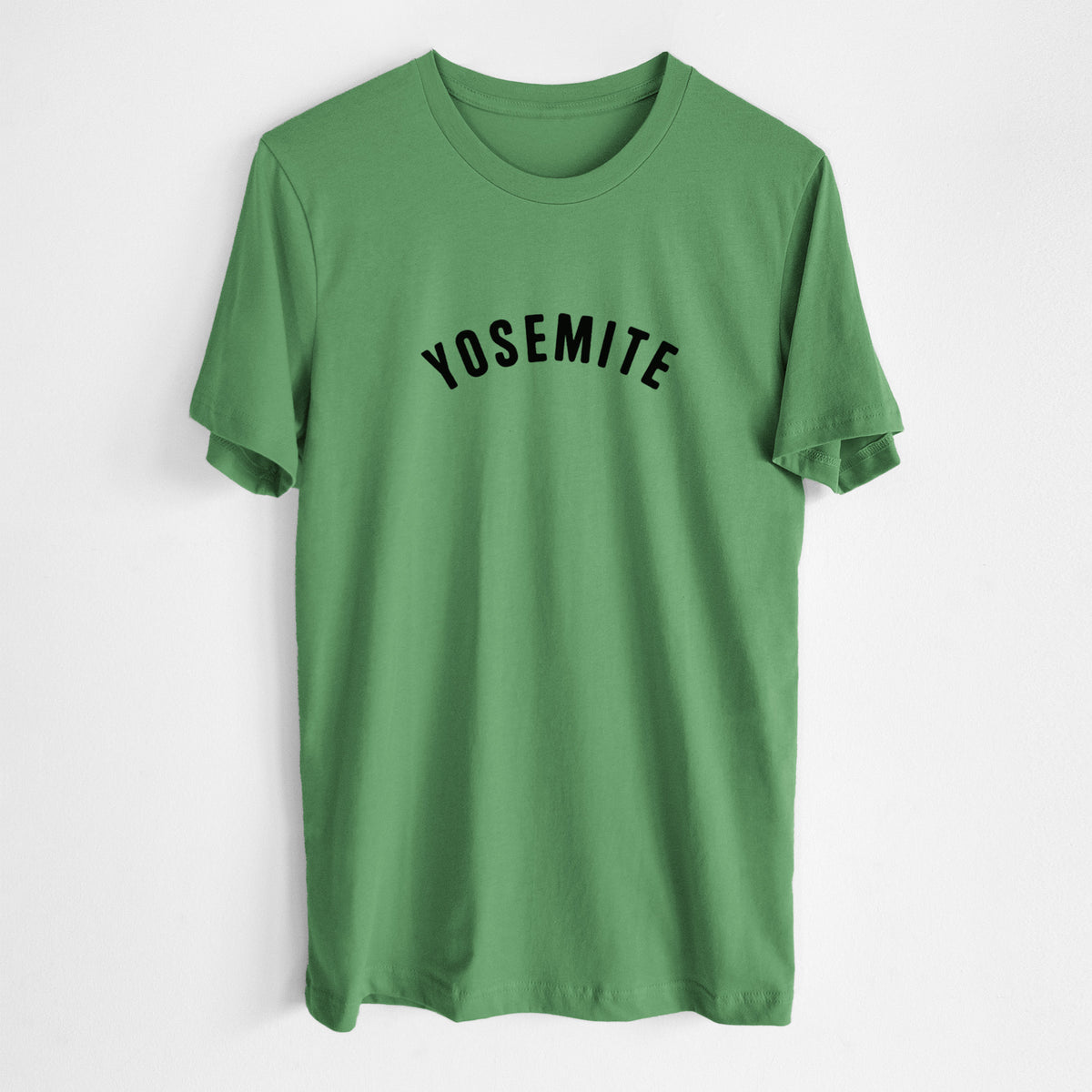 Leaf green lightweight cotton t-shirt laid flat, printed with the word Yosemite in bold black letters arched across the chest.