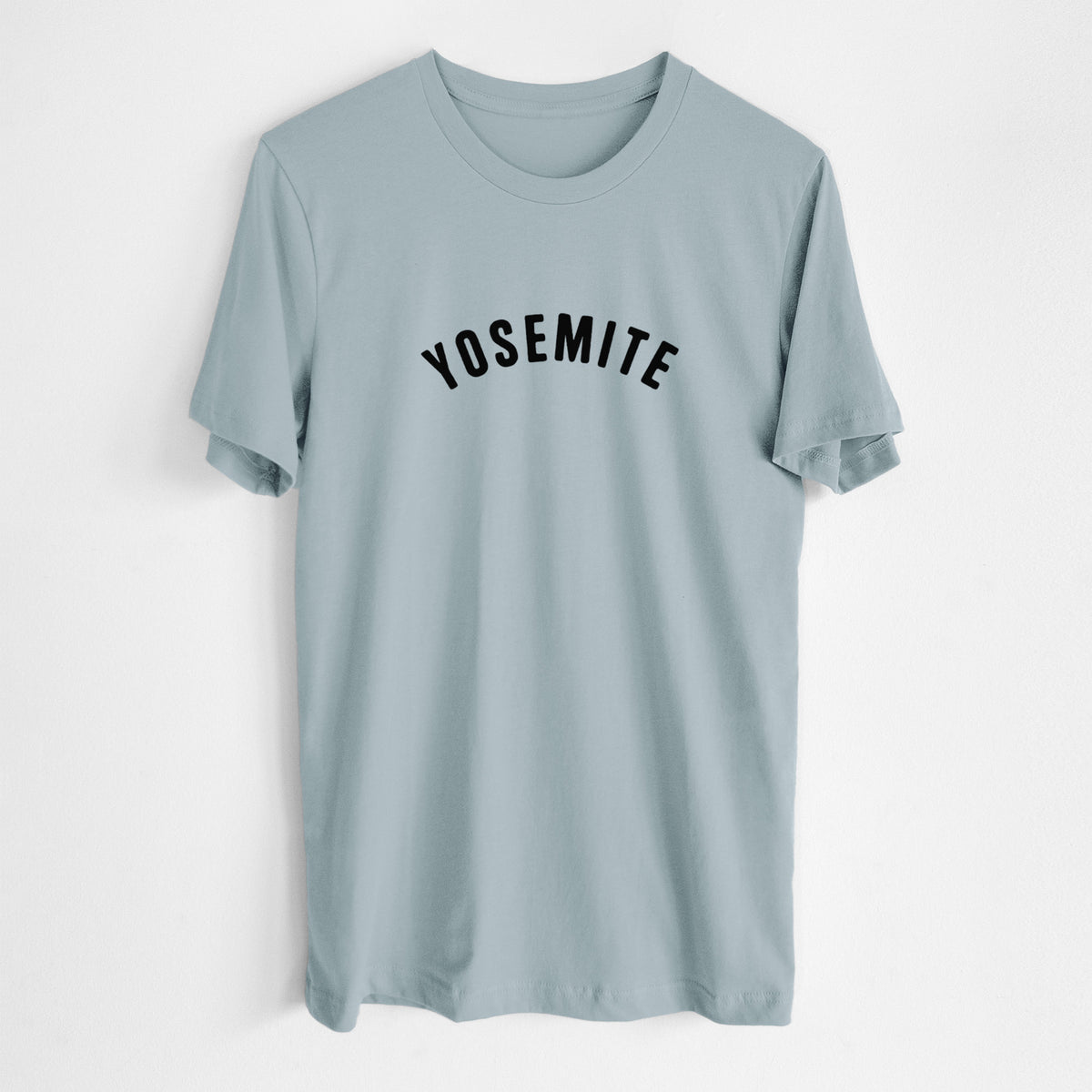 Vintage denim lightweight cotton t-shirt laid flat, printed with the word Yosemite in bold black letters arched across the chest.
