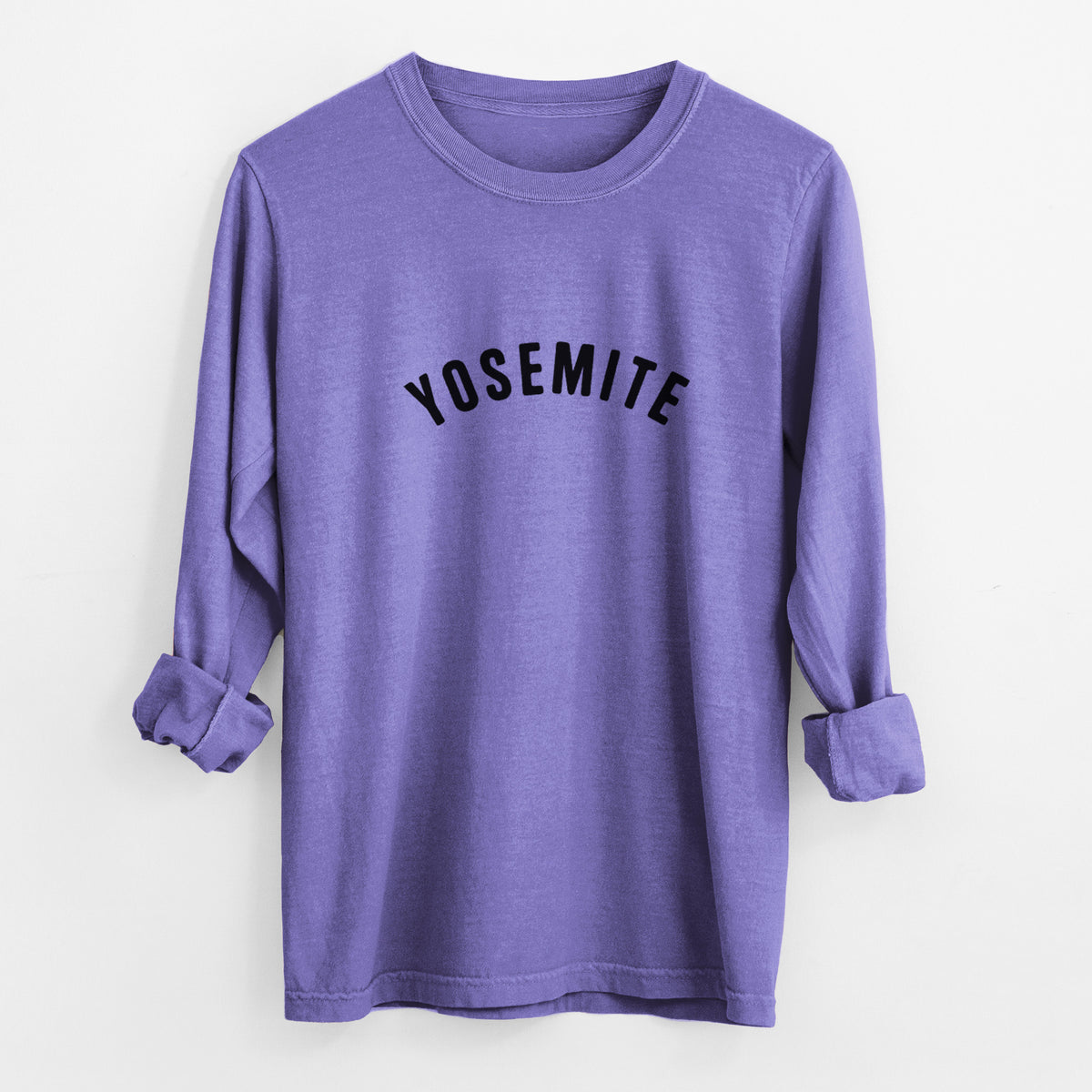 Violet purple Comfort Colors long sleeve shirt laid flat with the cuffs rolled, printed with the word Yosemite in bold black letters arched across the chest.