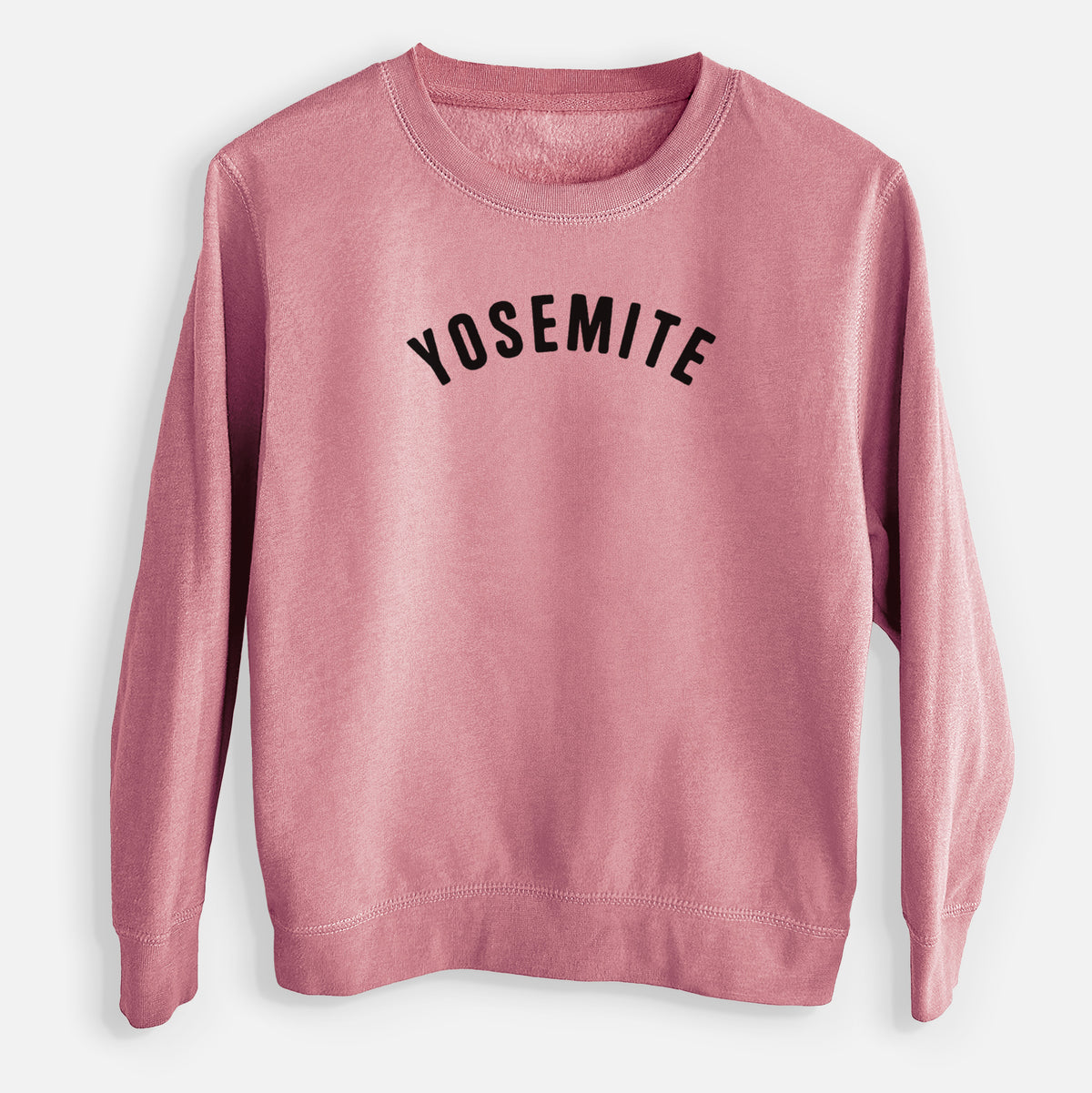 Mauve pink youth crewneck sweatshirt laid flat, printed with the word Yosemite in bold black letters arched across the chest.