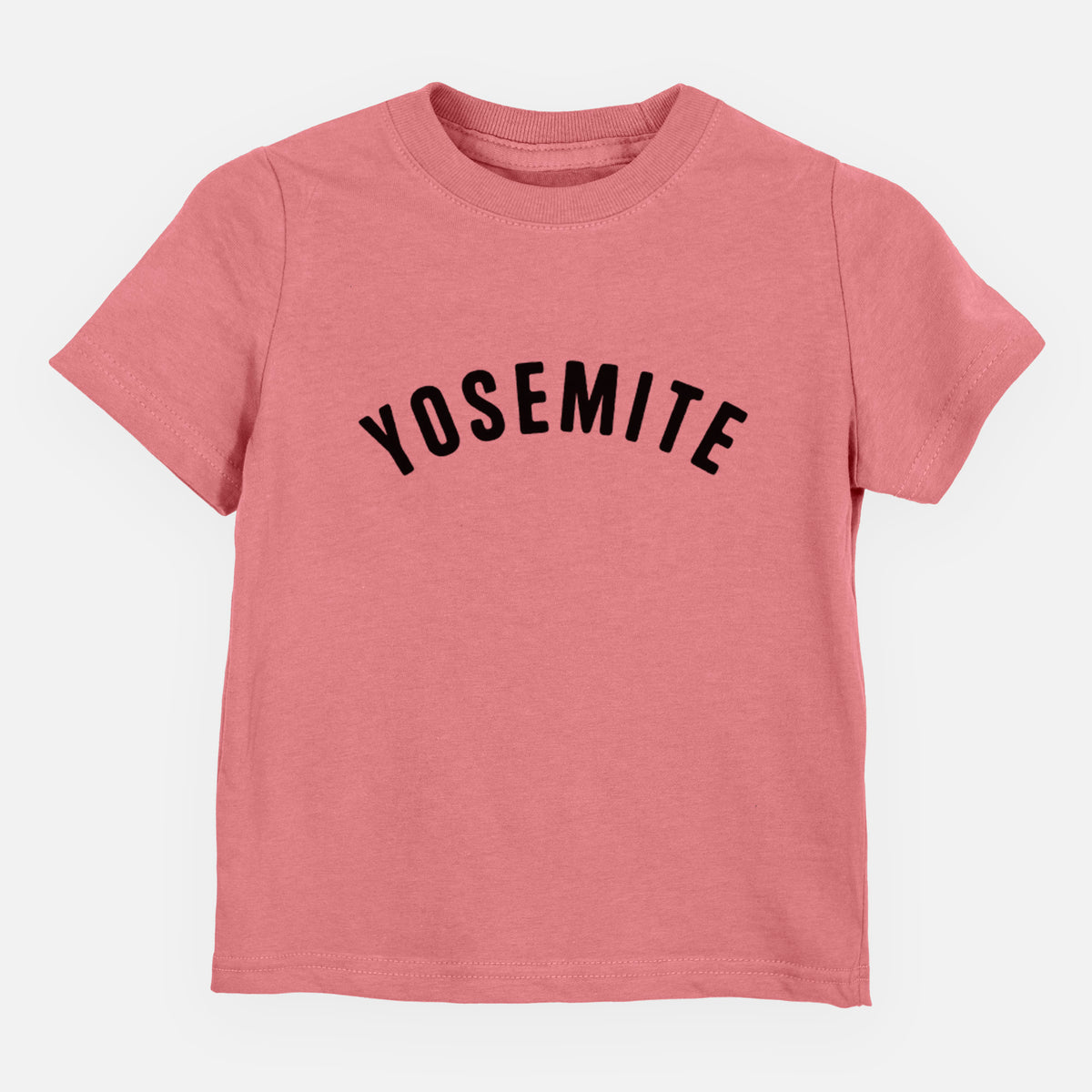 Mauve pink toddler t-shirt laid flat, printed with the word Yosemite in bold black letters arched across the chest.