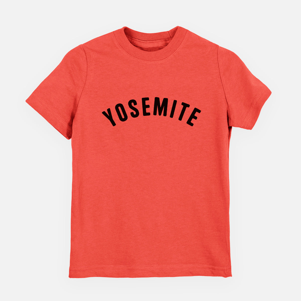 Passionfruit pink youth t-shirt laid flat, printed with the word Yosemite in bold black letters arched across the chest.