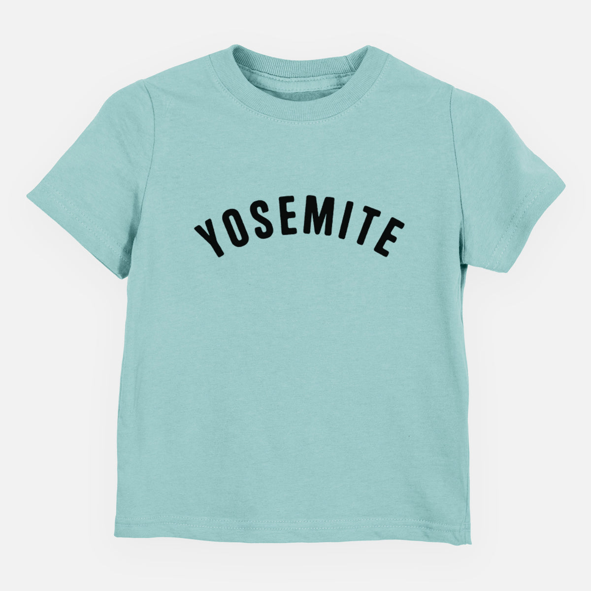 Saltwater toddler t-shirt laid flat, printed with the word Yosemite in bold black letters arched across the chest.