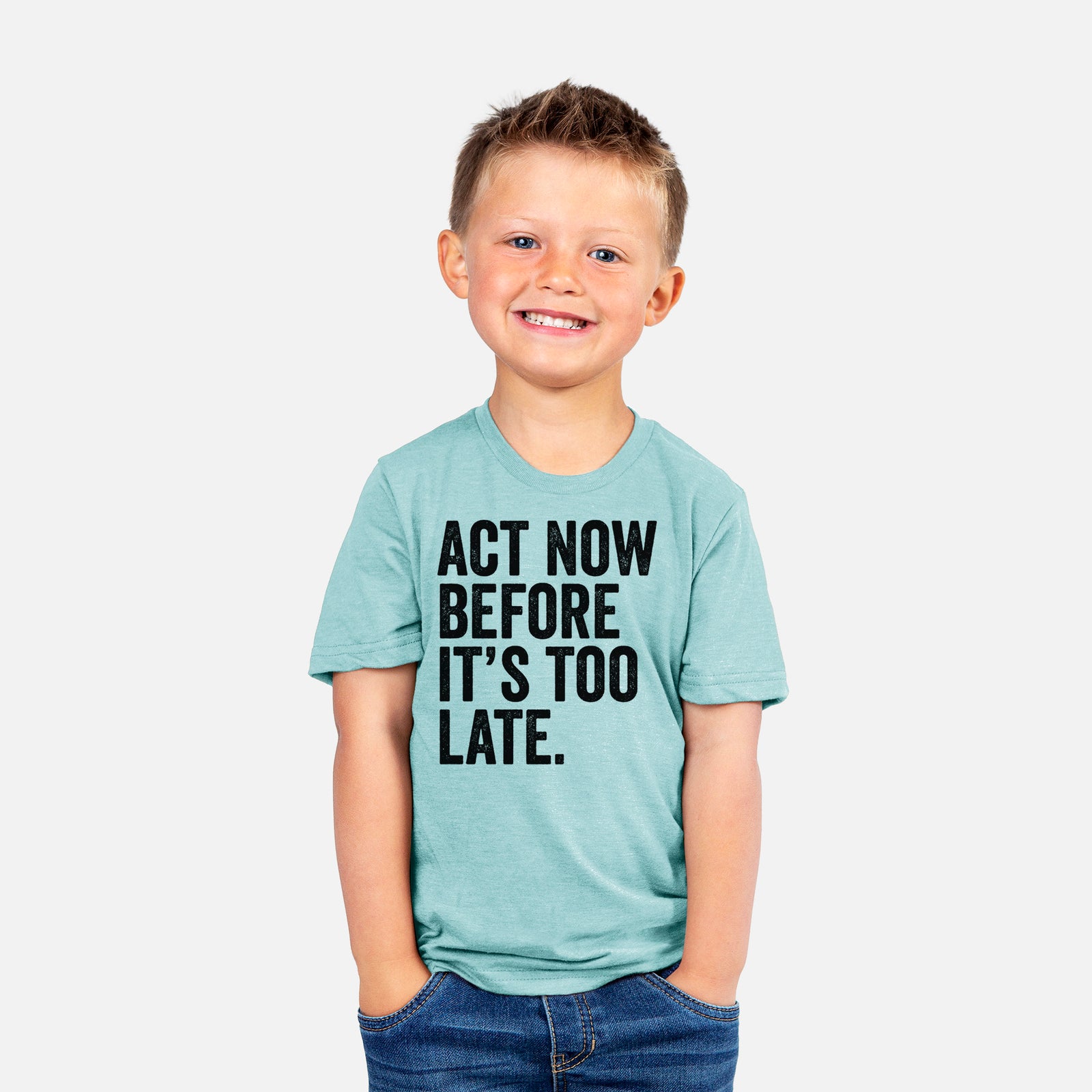 Basil green youth t-shirt laid flat, printed with bold black words reading Act Now Before It's Too Late.
