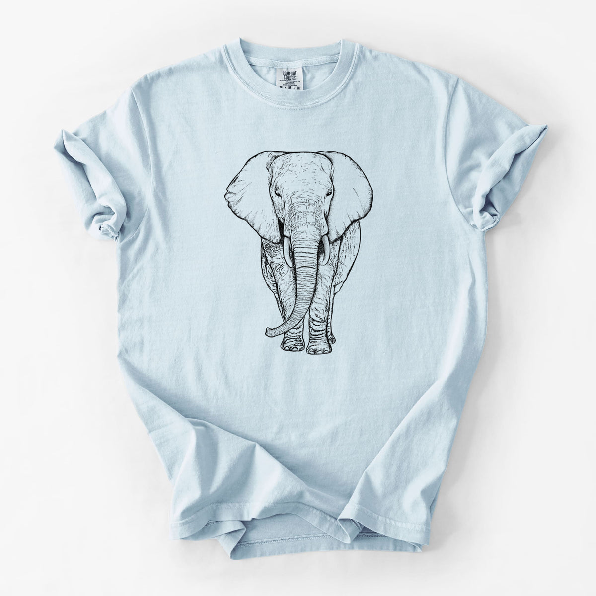 Chambray blue Comfort Colors t-shirt laid flat, printed with a black ink line drawing of an African elephant facing forward with large ears and tusks.