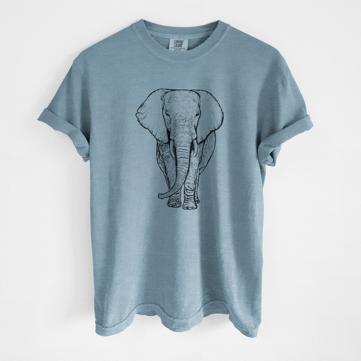 Steel blue Comfort Colors t-shirt laid flat, printed with a black ink line drawing of an African elephant facing forward with large ears and tusks.