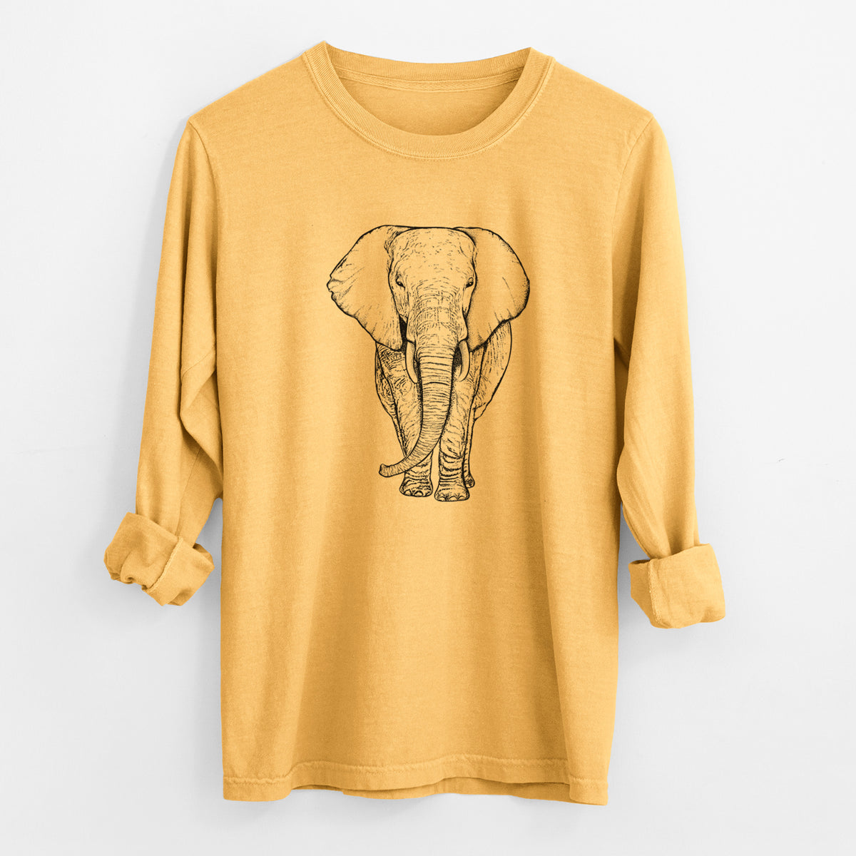 Golden wheat yellow Comfort Colors long sleeve shirt laid flat with the cuffs rolled, printed with a black ink line drawing of an African elephant facing forward with large ears and tusks.