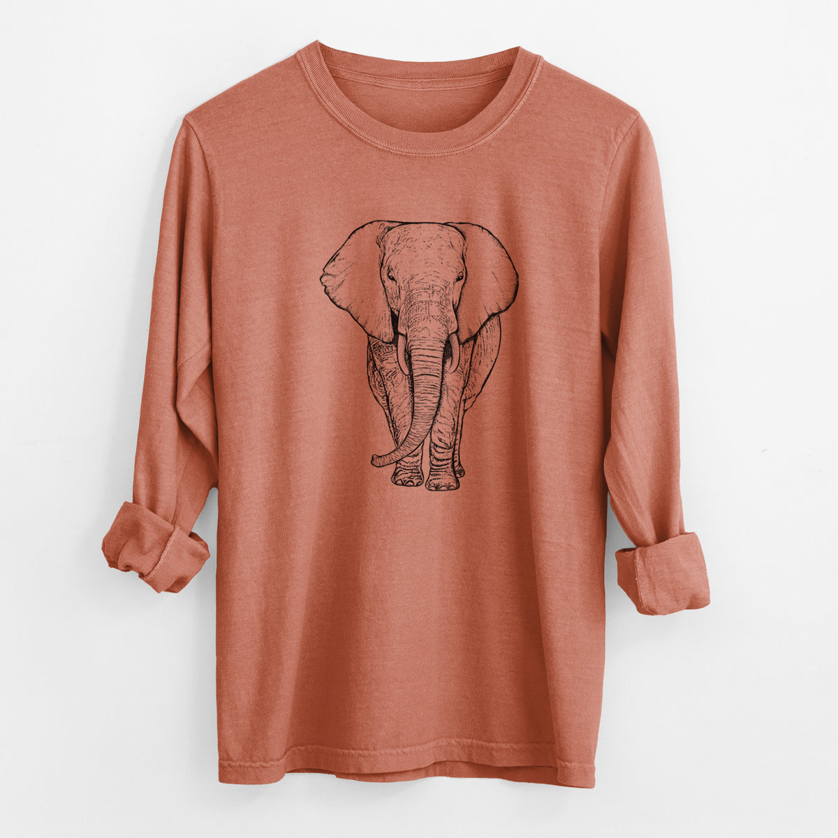 Yam burnt orange Comfort Colors long sleeve shirt laid flat with the cuffs rolled, printed with a black ink line drawing of an African elephant facing forward with large ears and tusks.
