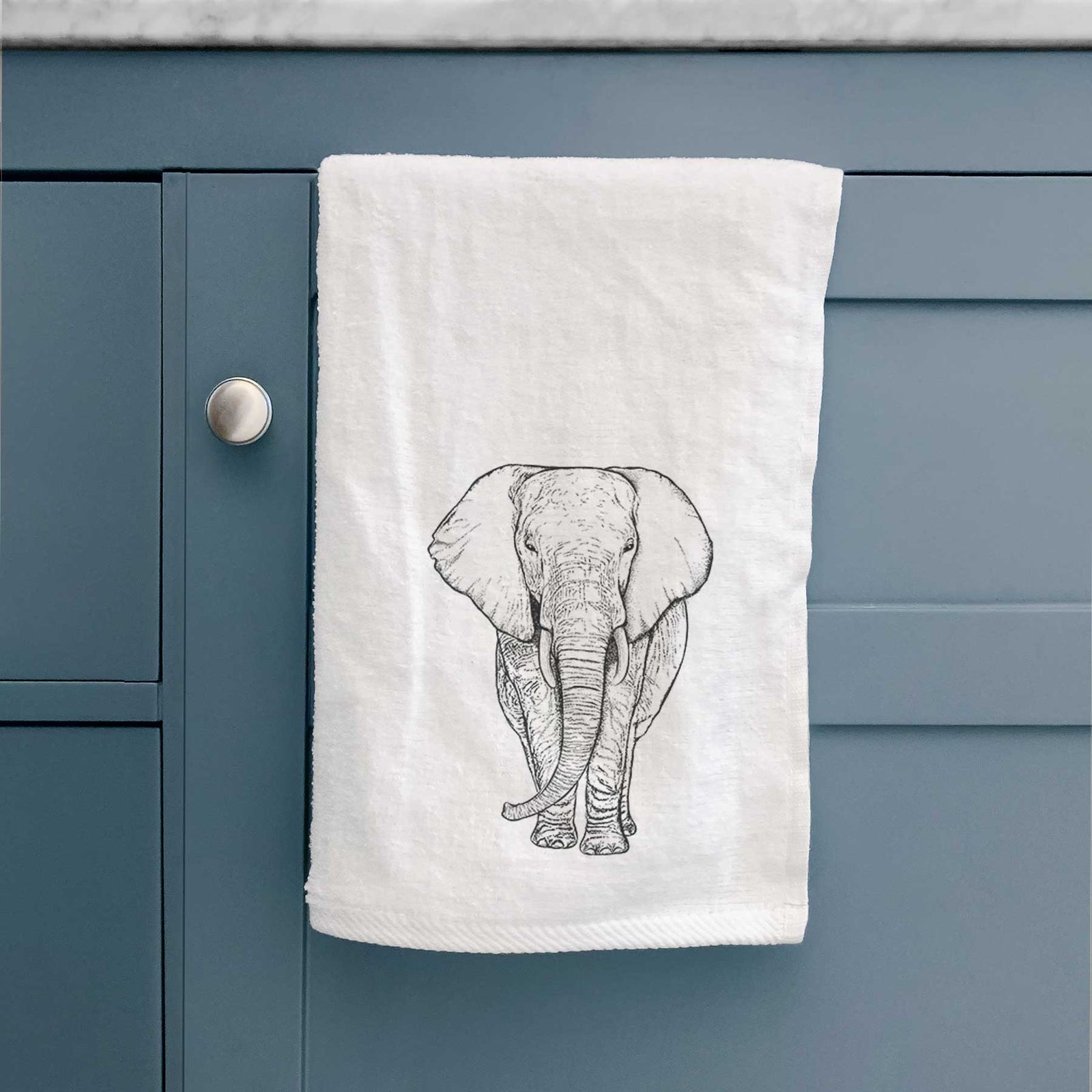 White hand towel printed with a black ink line drawing of an African elephant facing forward with large ears and tusks.