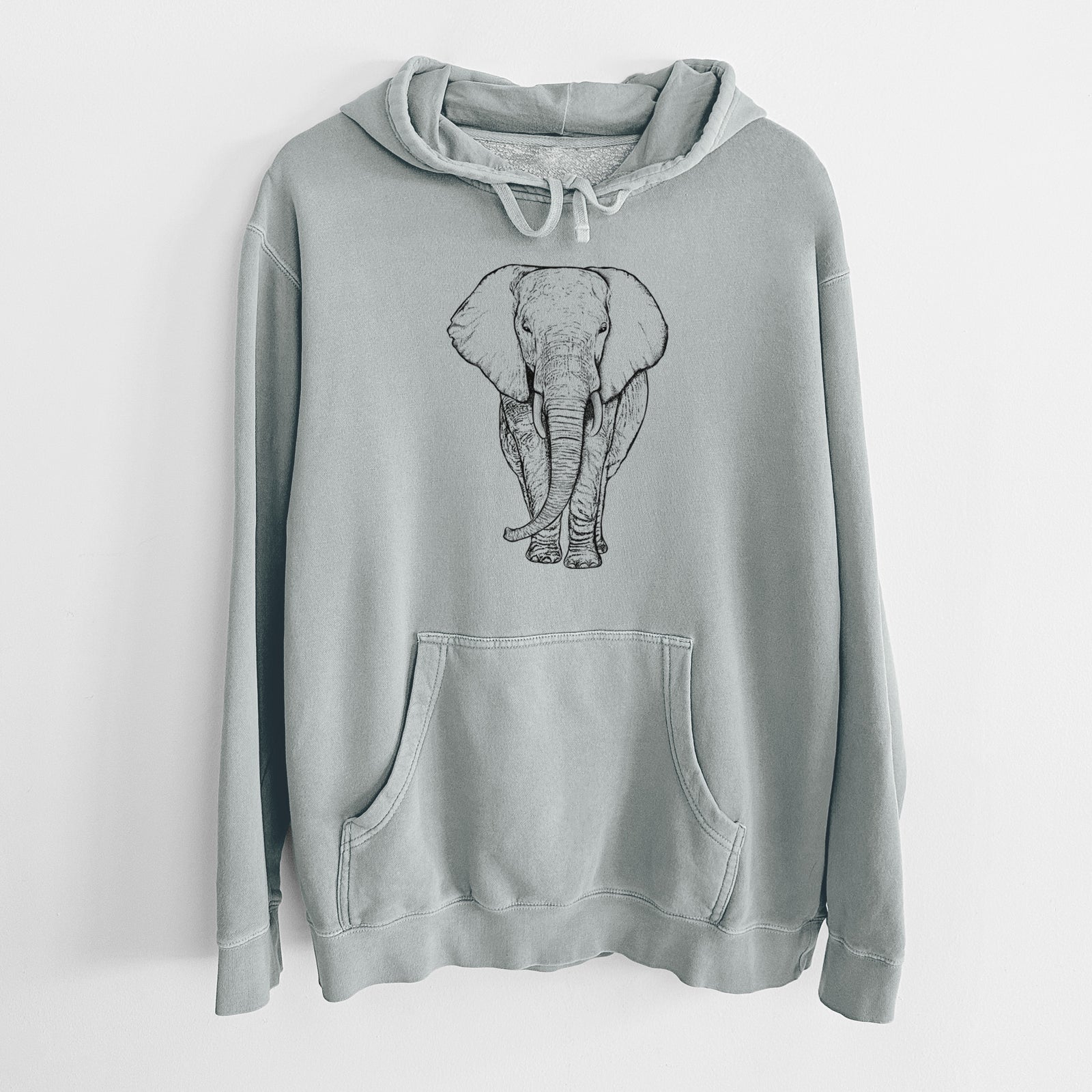 Sage green pigment dyed hoodie laid flat, printed with a black ink line drawing of an African elephant facing forward with large ears and tusks.