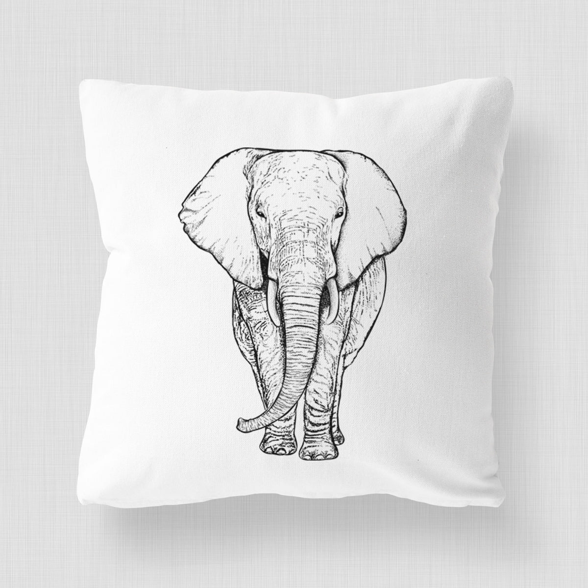 White pillow cover printed with a black ink line drawing of an African elephant facing forward with large ears and tusks.