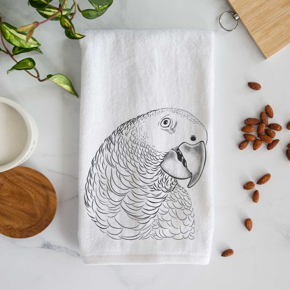White hand towel printed with a detailed black ink portrait of an African grey parrot's head.