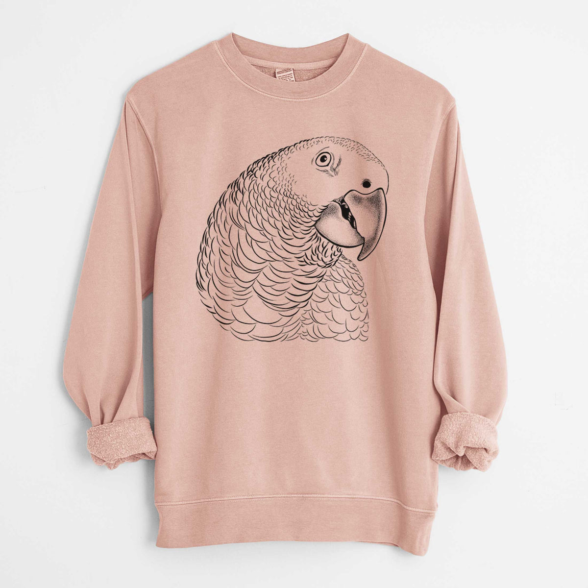 Dusty pink pigment dyed crewneck sweatshirt laid flat with the sleeves rolled, printed with a detailed black ink portrait of an African grey parrot's head.