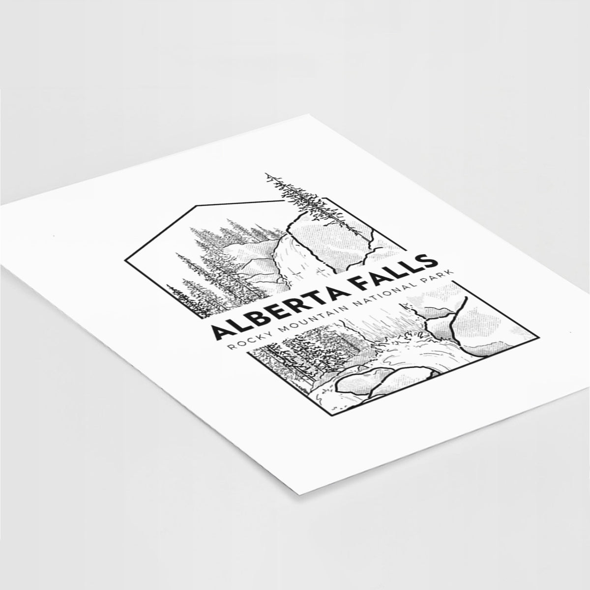 Art print of a black line art badge of Alberta Falls with pine trees, with the words Alberta Falls, Rocky Mountain National Park, lying at an angle on a white surface.