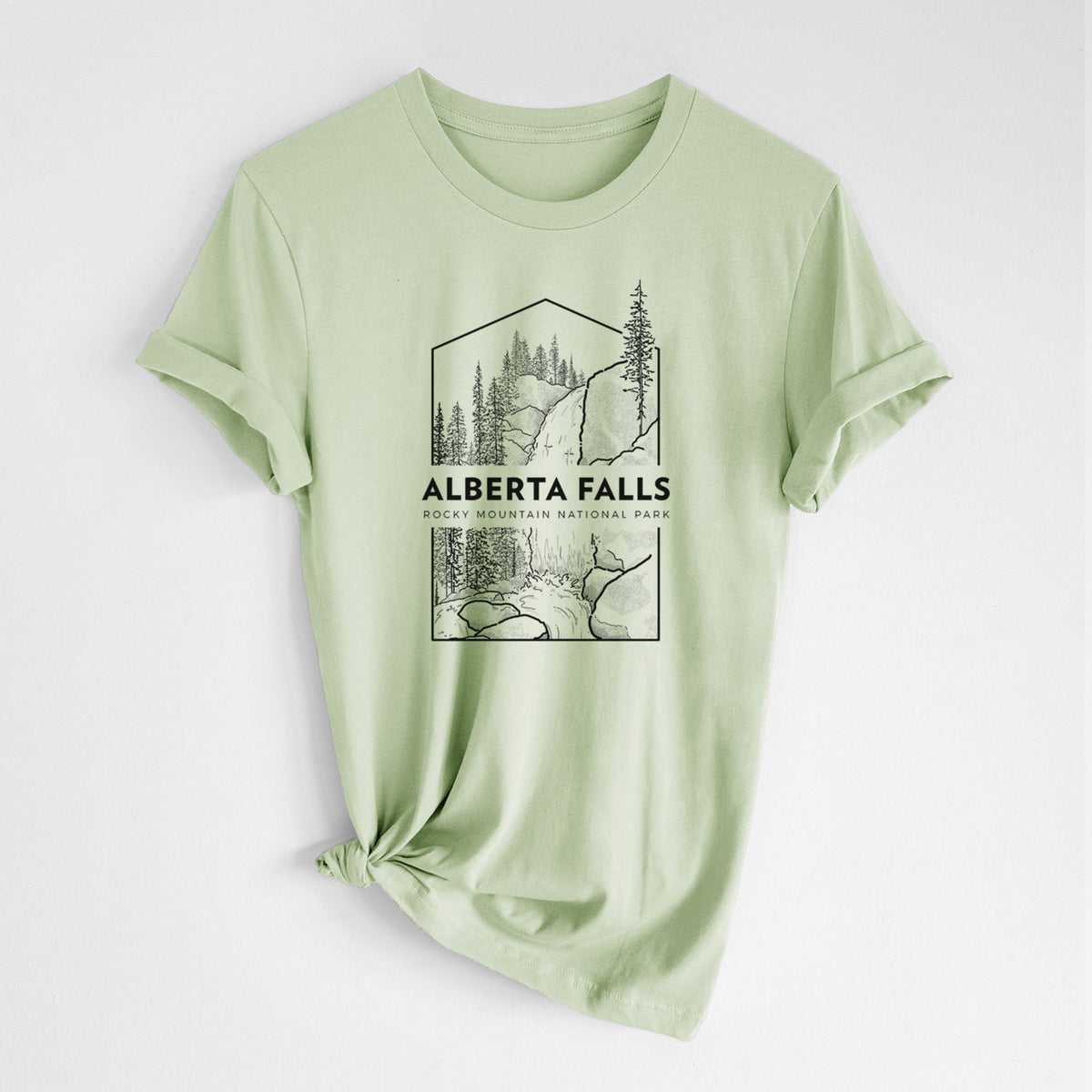 Spring green lightweight cotton t-shirt laid flat with the sleeves rolled, printed with a black line art badge of Alberta Falls with pine trees, with the words Alberta Falls, Rocky Mountain National Park.