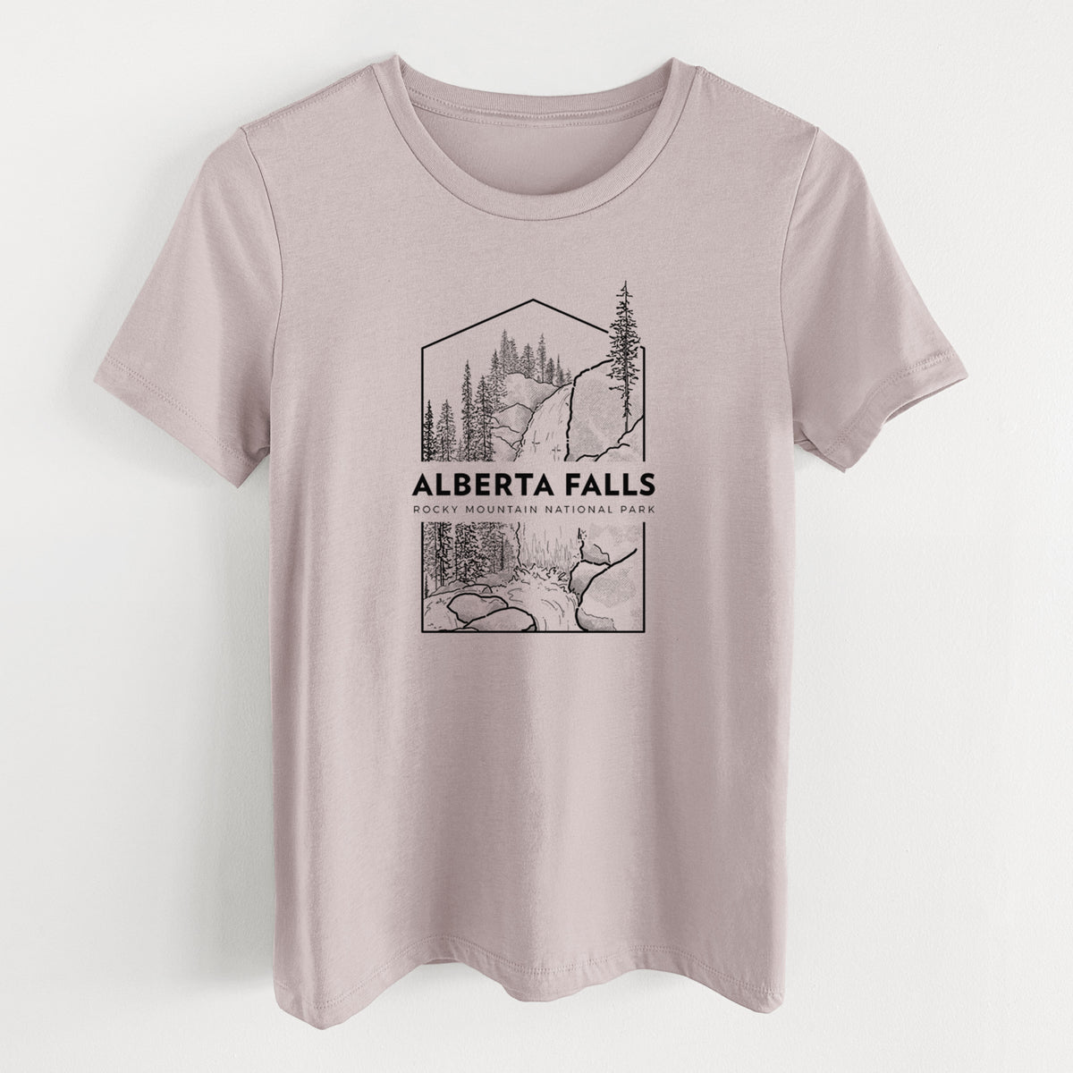 Pink gravel women's relaxed fit cotton t-shirt laid flat, printed with a black line art badge of Alberta Falls with pine trees, with the words Alberta Falls, Rocky Mountain National Park.