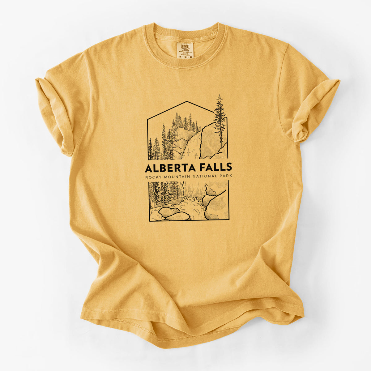 Golden wheat yellow Comfort Colors t-shirt laid flat, printed with a black line art badge of Alberta Falls with pine trees, with the words Alberta Falls, Rocky Mountain National Park.