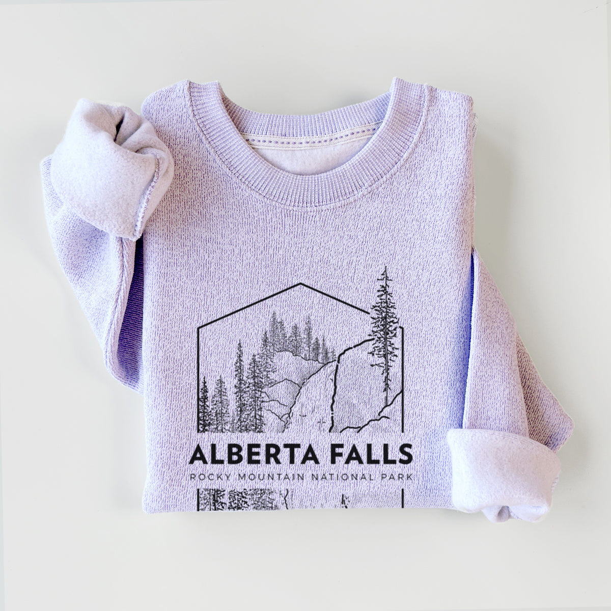 Ice purple knit sweatshirt printed with a black line art badge of Alberta Falls with pine trees, with the words Alberta Falls, Rocky Mountain National Park, styled flat.