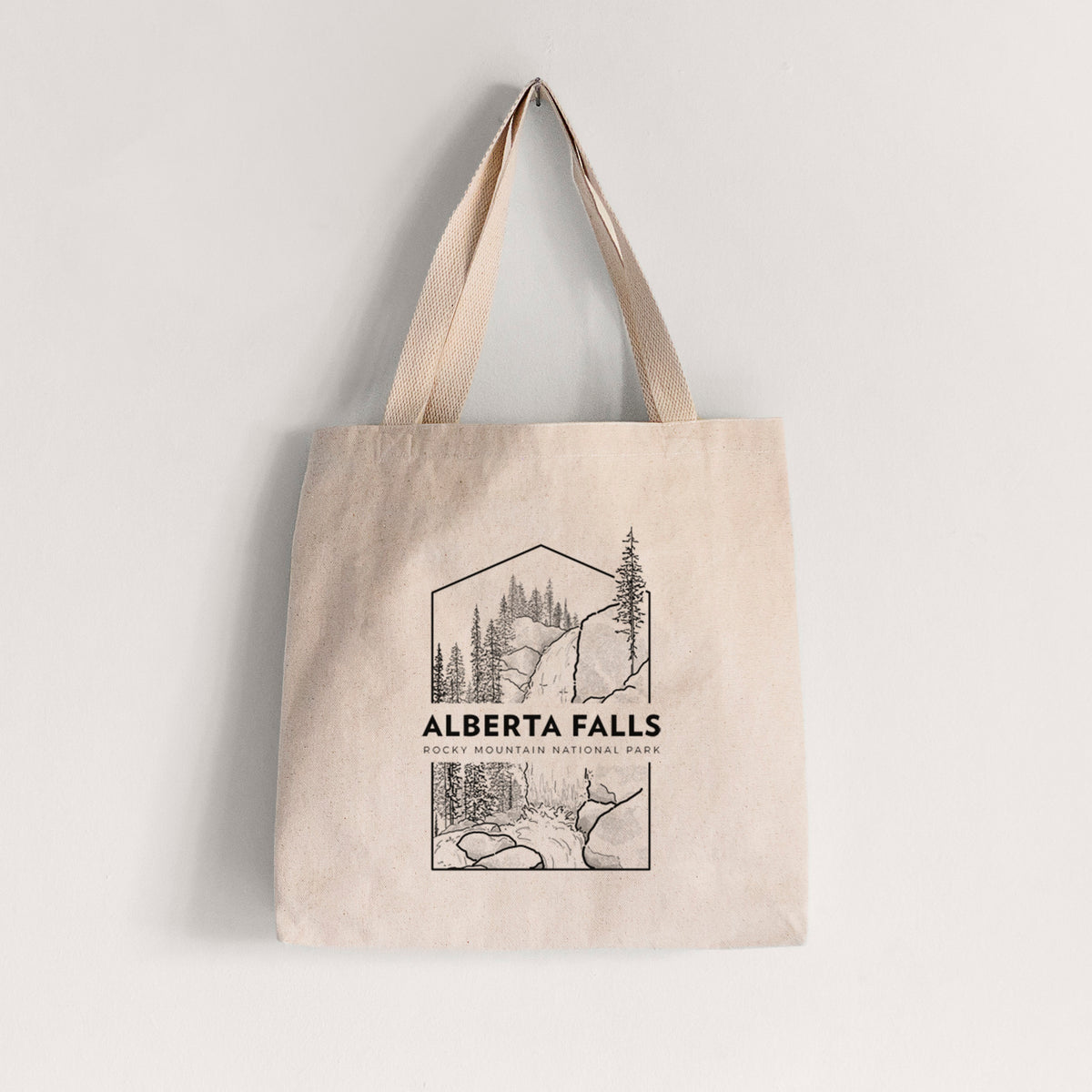 Natural canvas tote bag printed with a black line art badge of Alberta Falls with pine trees, with the words Alberta Falls, Rocky Mountain National Park.