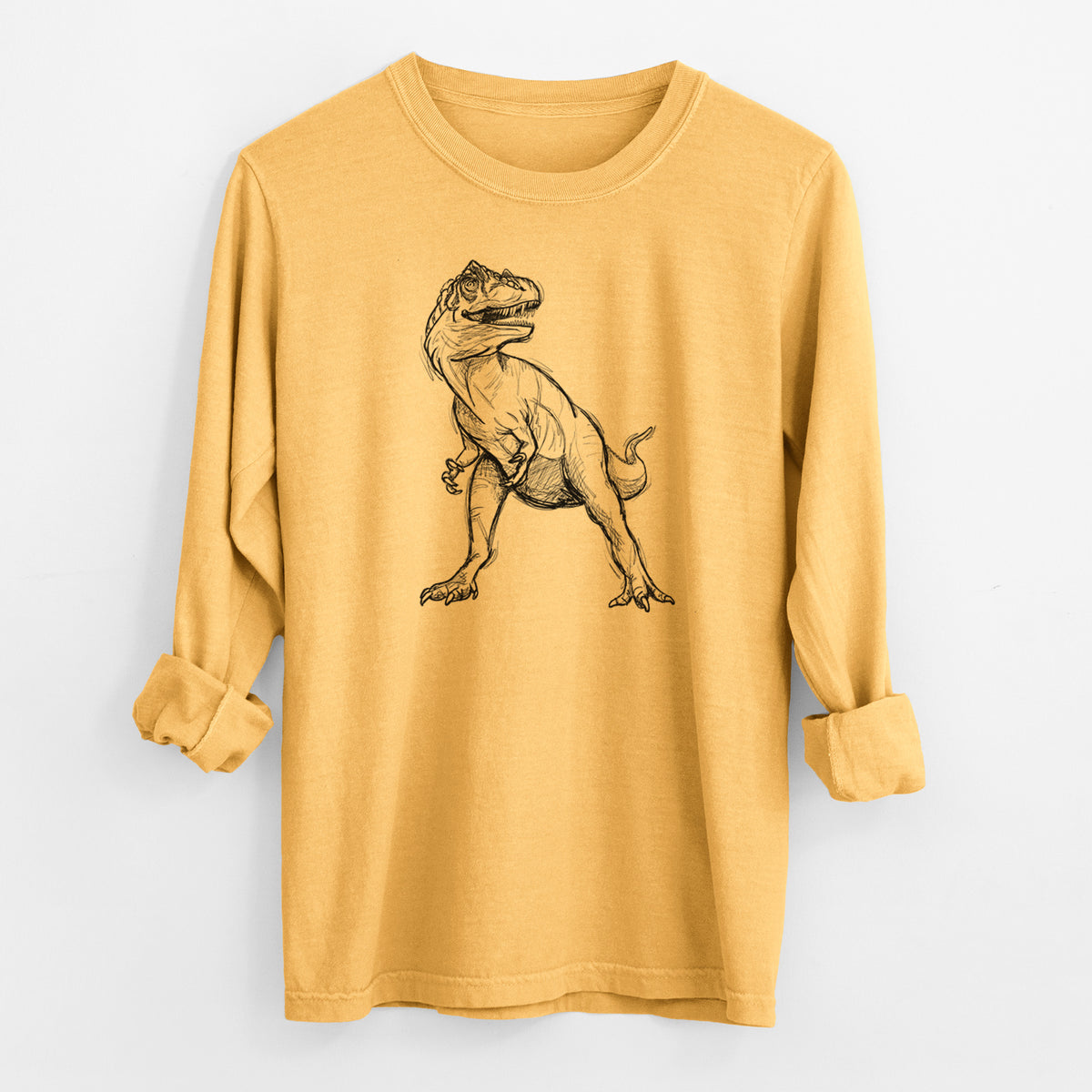 Golden wheat yellow Comfort Colors long sleeve shirt laid flat with the cuffs rolled, printed with a black ink illustration of an Allosaurus walking.