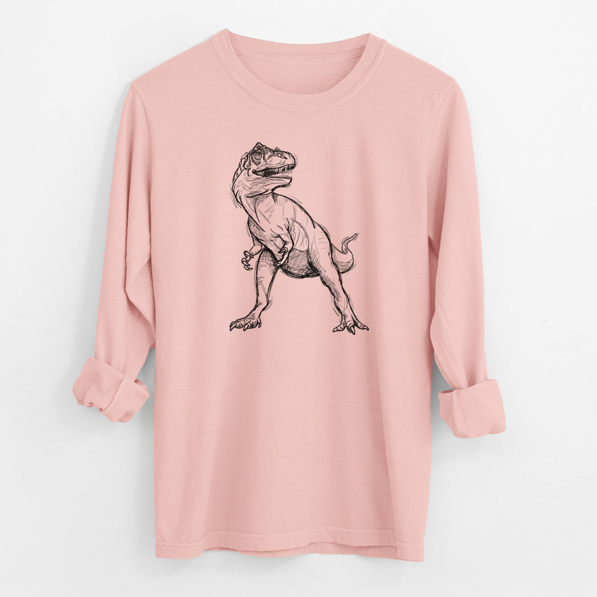 Peachy Comfort Colors long sleeve shirt laid flat with the cuffs rolled, printed with a black ink illustration of an Allosaurus walking.