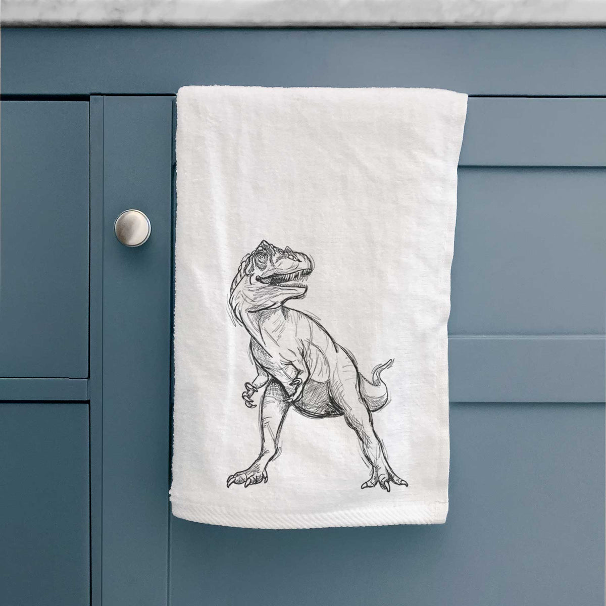 White hand towel printed with a black ink illustration of an Allosaurus walking.