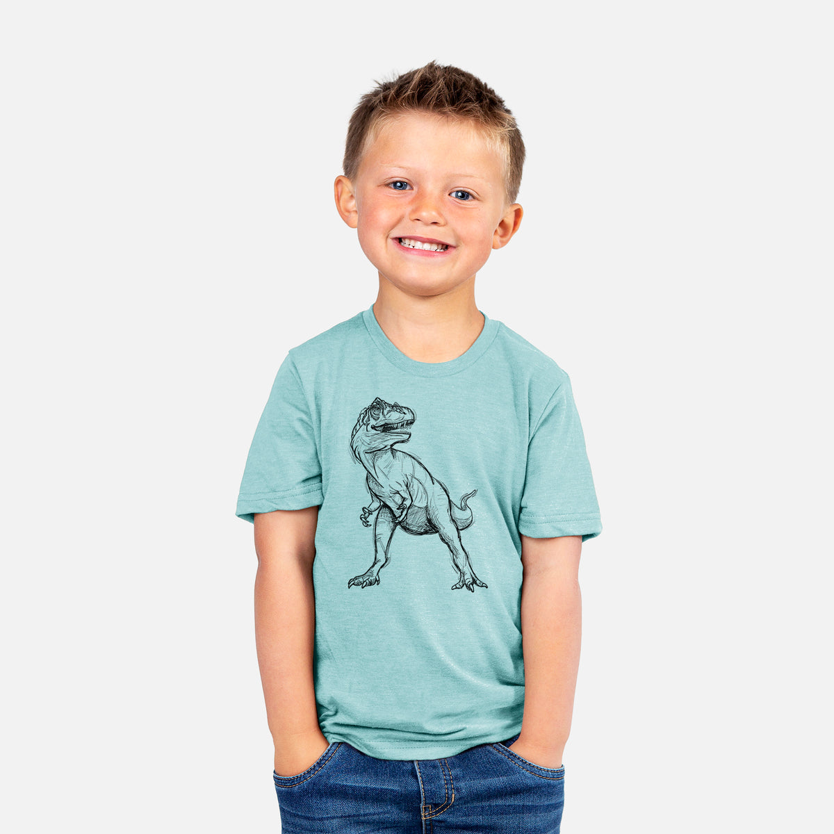 Smiling boy wearing a youth t-shirt printed with a black ink illustration of an Allosaurus walking.