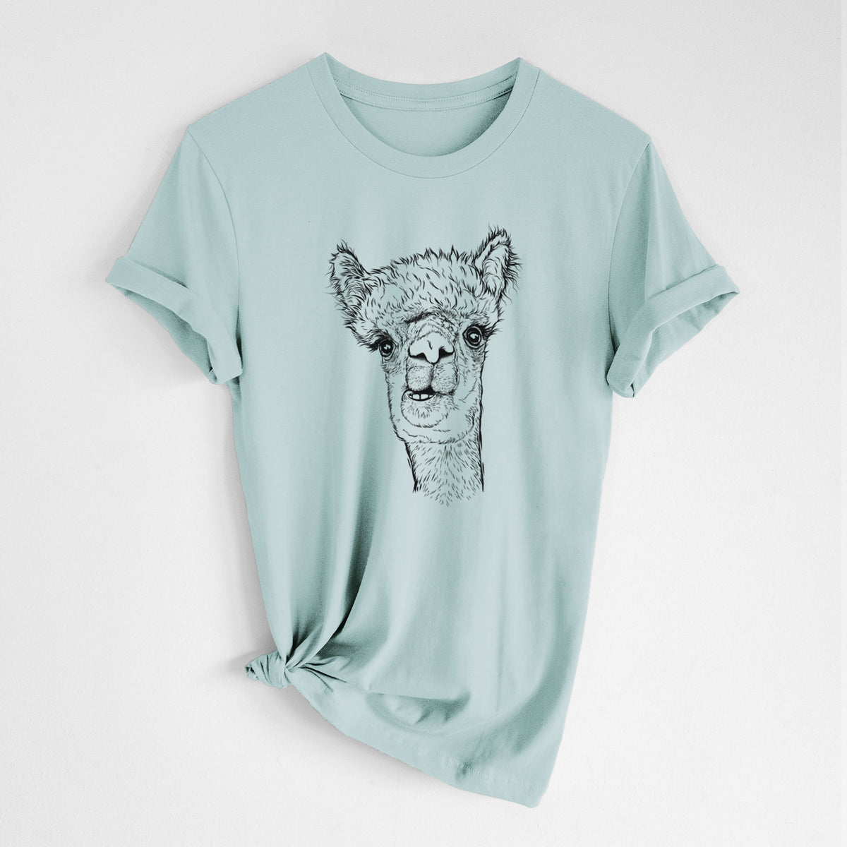 Dusty blue lightweight cotton t-shirt laid flat with the sleeves rolled, printed with a detailed black ink portrait of a fluffy alpaca's head and neck.