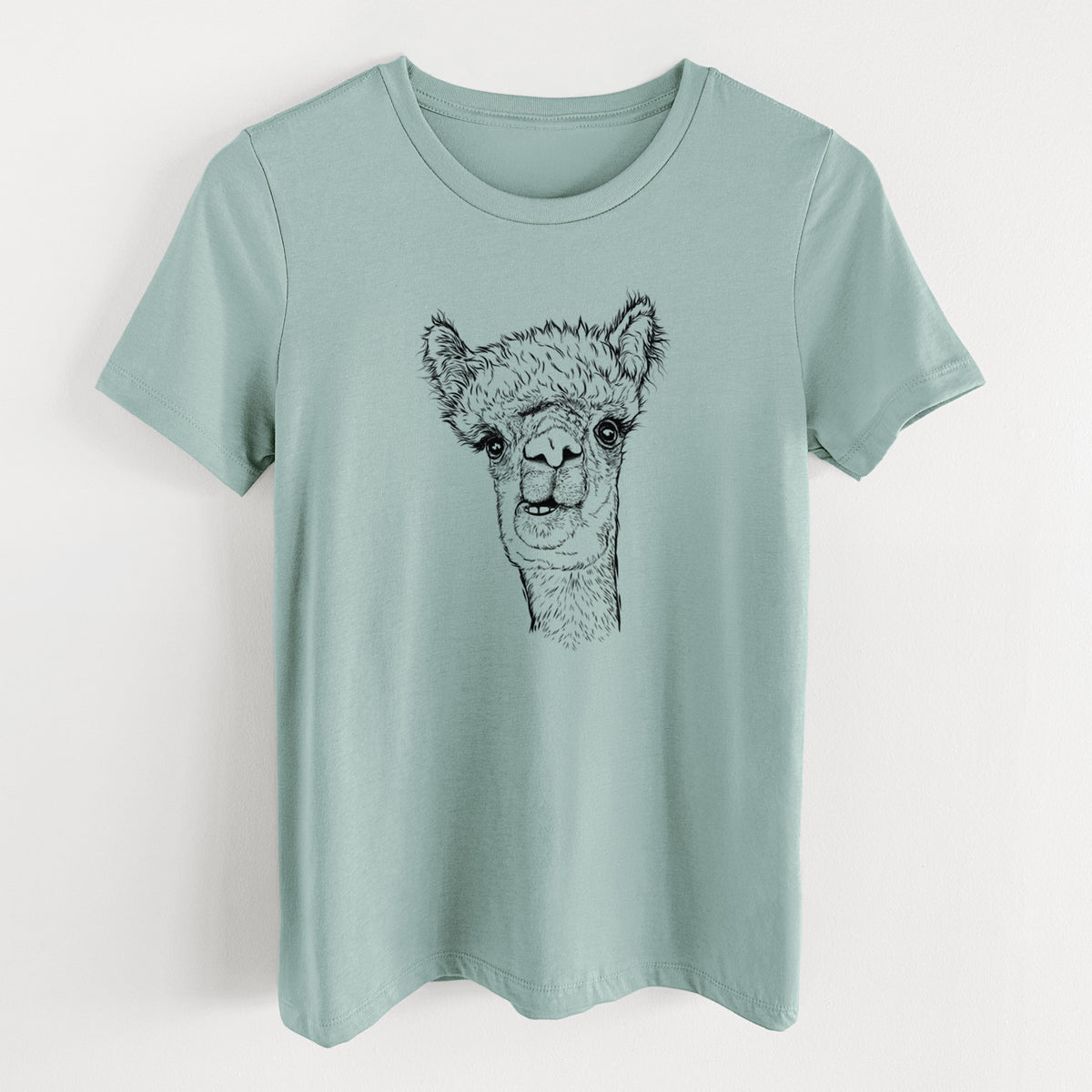 Dusty blue women's relaxed fit cotton t-shirt laid flat, printed with a detailed black ink portrait of a fluffy alpaca's head and neck.