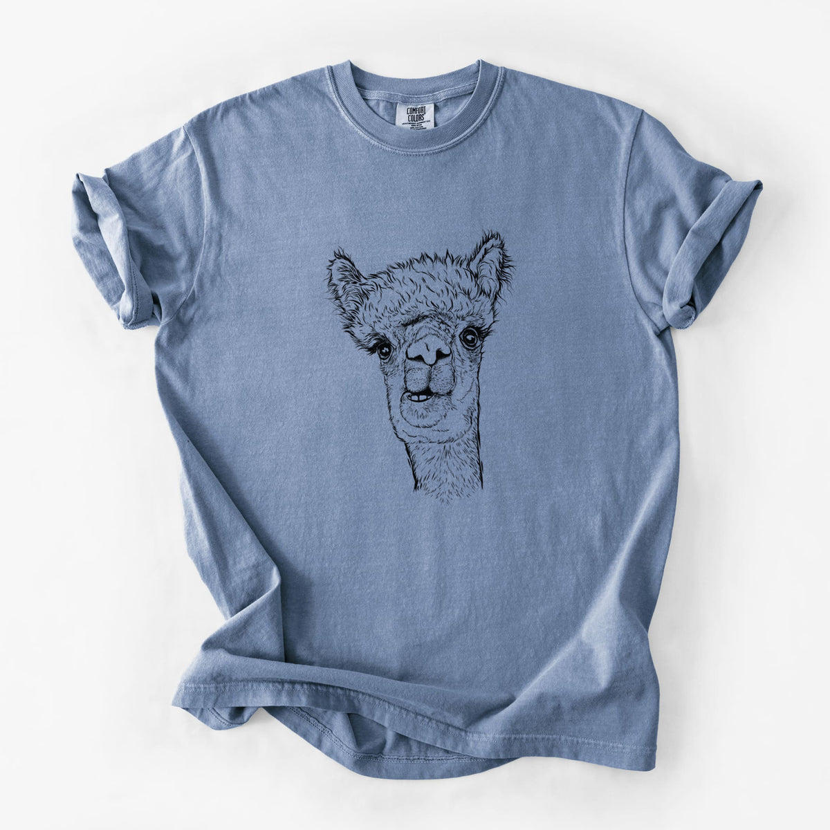Blue jean Comfort Colors t-shirt laid flat, printed with a detailed black ink portrait of a fluffy alpaca's head and neck.