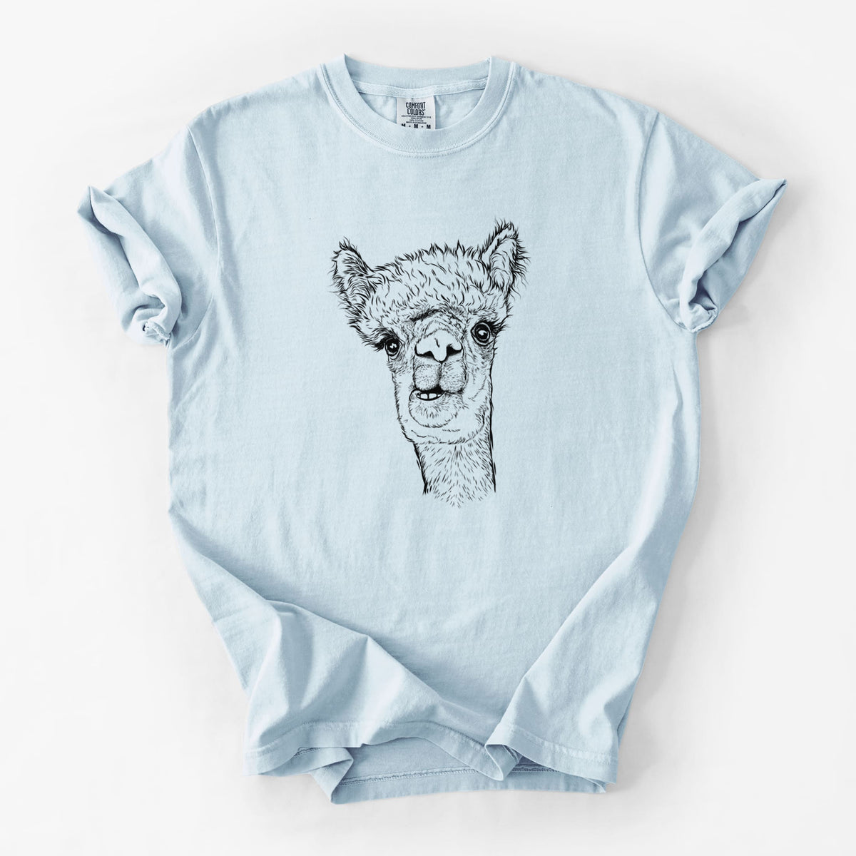 Chambray blue Comfort Colors t-shirt laid flat, printed with a detailed black ink portrait of a fluffy alpaca's head and neck.