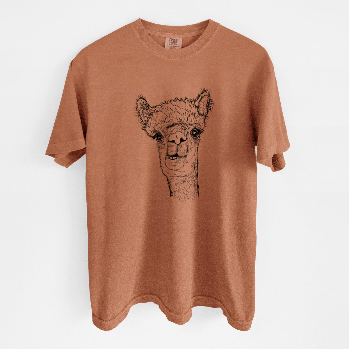 Yam burnt orange Comfort Colors t-shirt laid flat, printed with a detailed black ink portrait of a fluffy alpaca's head and neck.