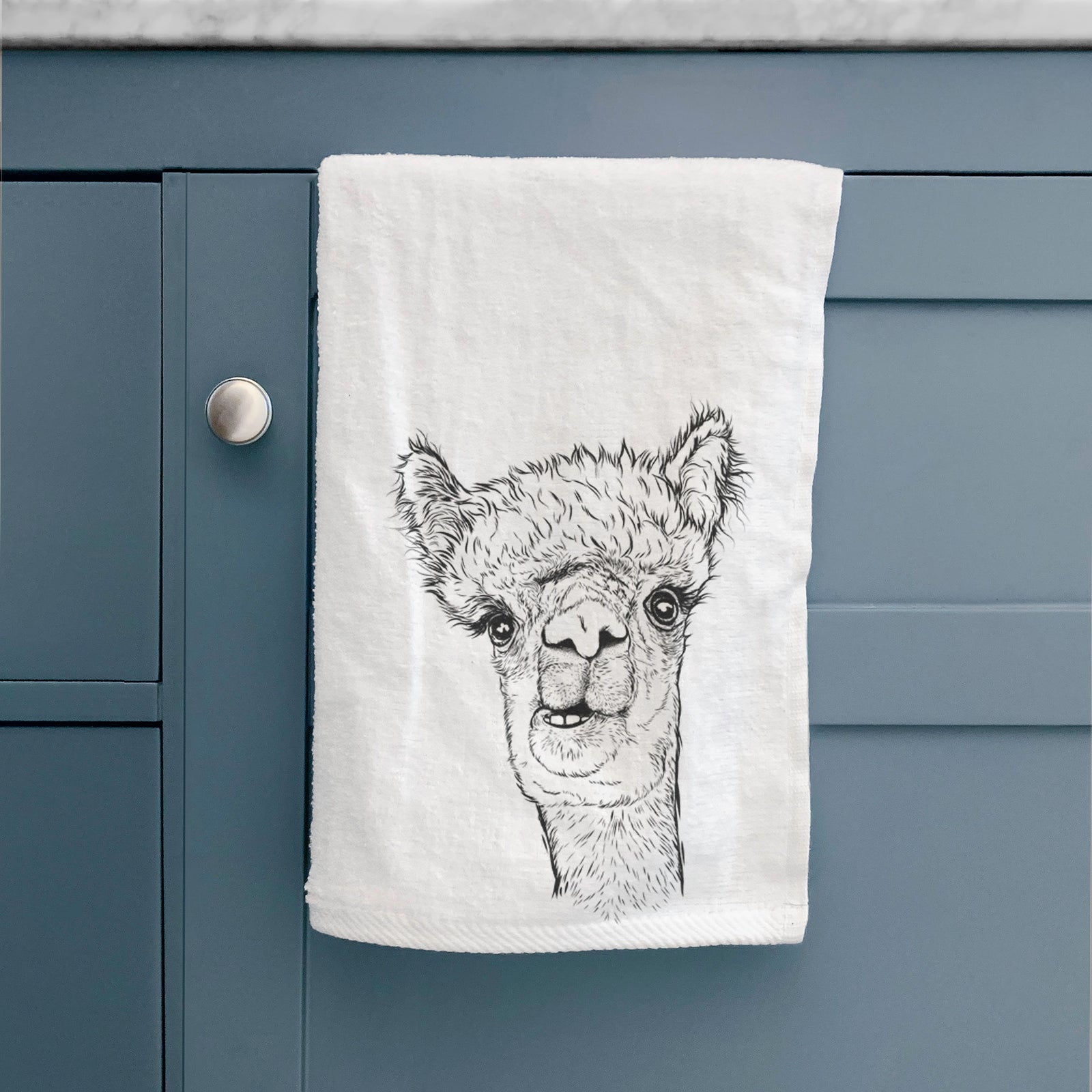 White hand towel printed with a detailed black ink portrait of a fluffy alpaca's head and neck.