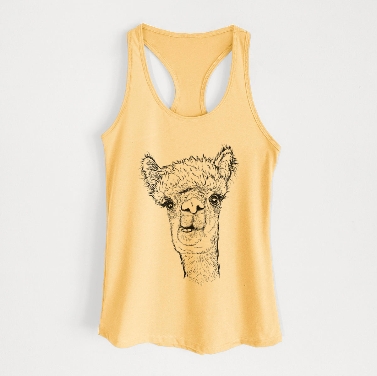 Banana cream women's racerback tank top laid flat, printed with a detailed black ink portrait of a fluffy alpaca's head and neck.
