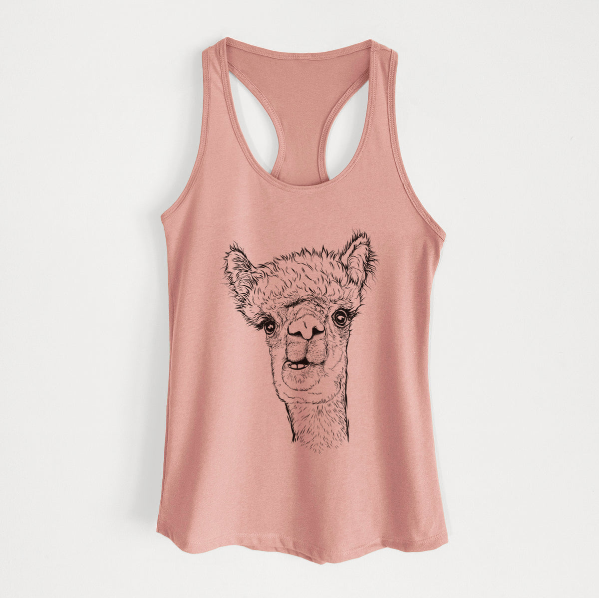 Desert pink women's racerback tank top laid flat, printed with a detailed black ink portrait of a fluffy alpaca's head and neck.