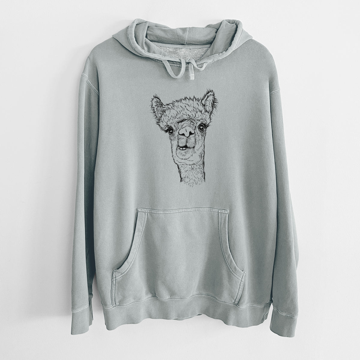 Sage green pigment dyed hoodie laid flat, printed with a detailed black ink portrait of a fluffy alpaca's head and neck.