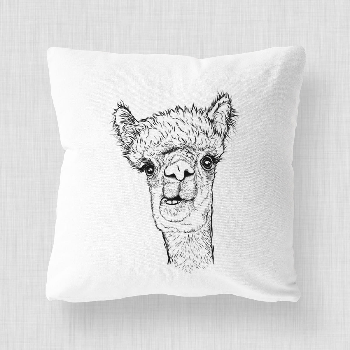 White pillow cover printed with a detailed black ink portrait of a fluffy alpaca's head and neck.