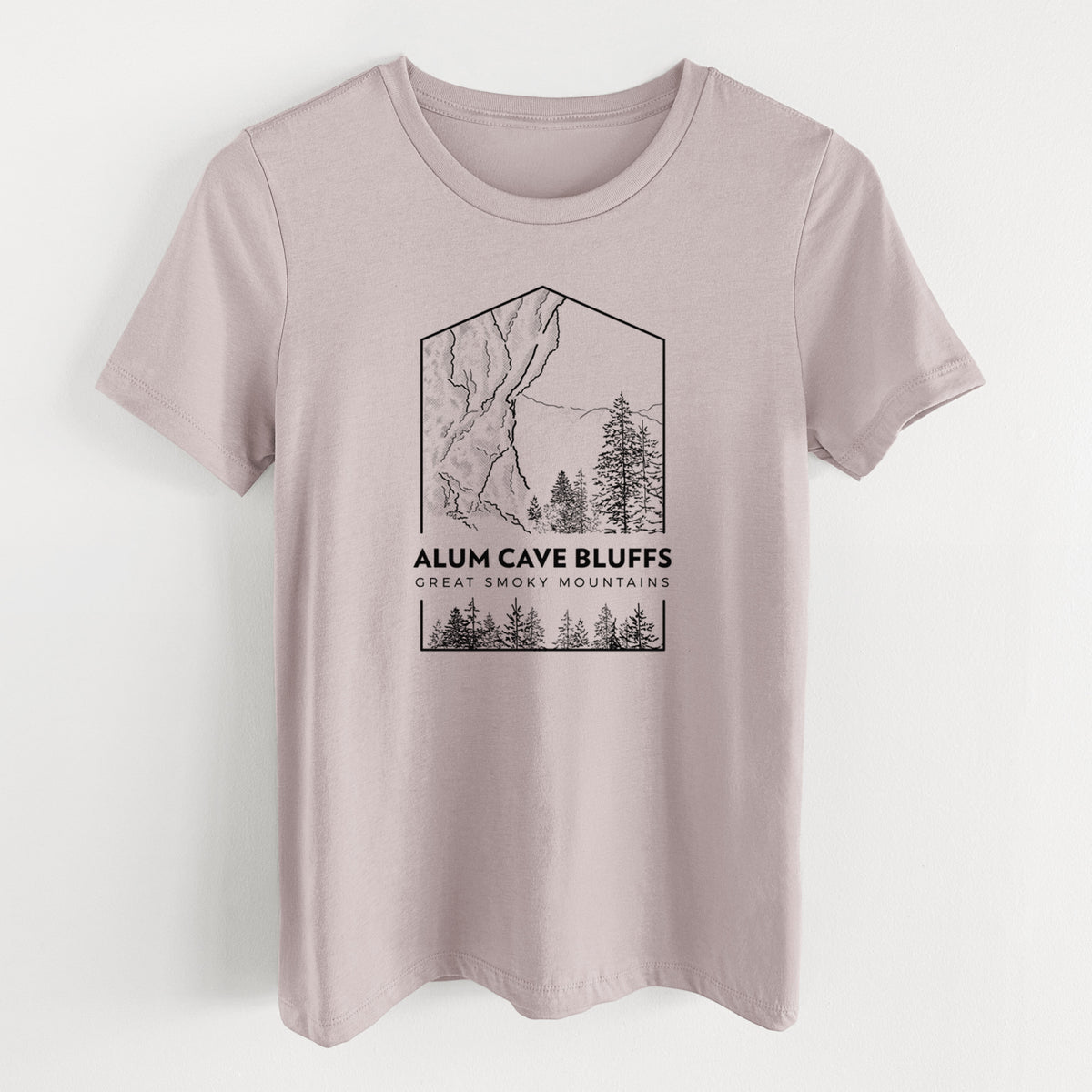Pink gravel women's relaxed fit cotton t-shirt laid flat, printed with a black line art badge of Alum Cave Bluffs with pine trees, with the words Alum Cave Bluffs, Great Smoky Mountains.