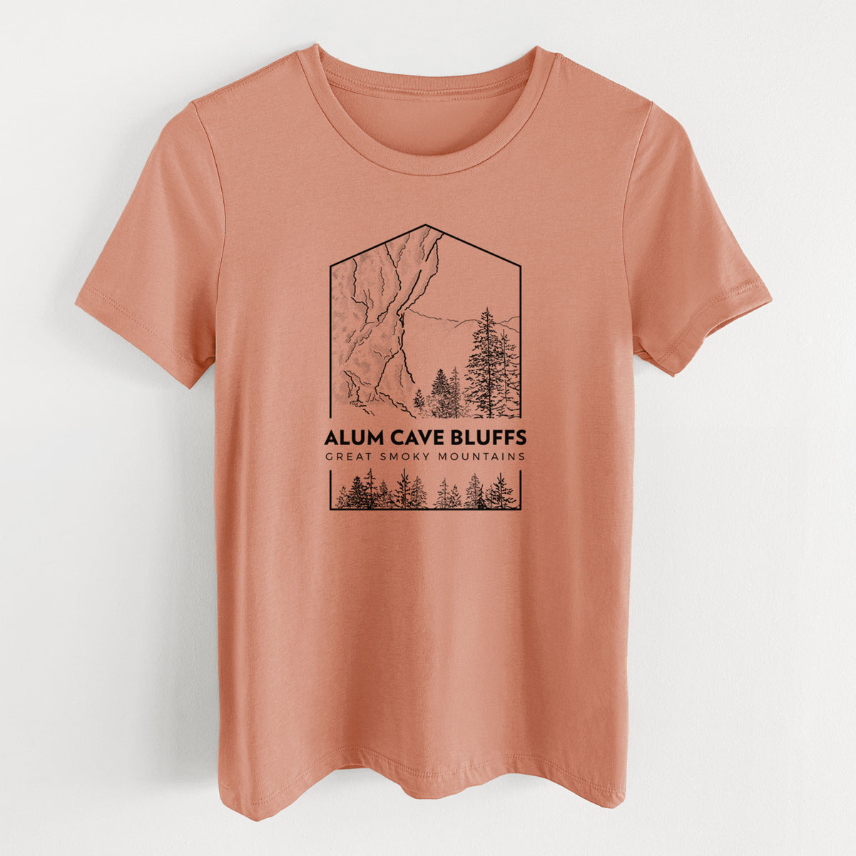 Terracotta orange women's relaxed fit cotton t-shirt laid flat, printed with a black line art badge of Alum Cave Bluffs with pine trees, with the words Alum Cave Bluffs, Great Smoky Mountains.