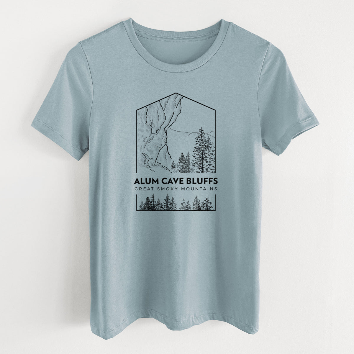 Vintage denim women's relaxed fit cotton t-shirt laid flat, printed with a black line art badge of Alum Cave Bluffs with pine trees, with the words Alum Cave Bluffs, Great Smoky Mountains.