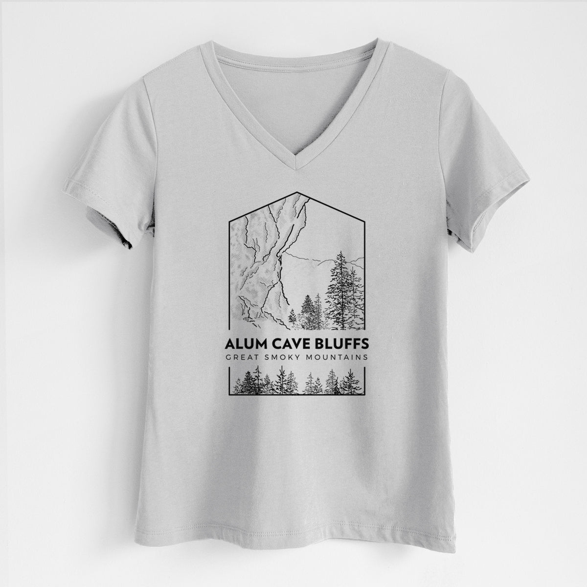 Lunar grey women's relaxed fit cotton V-neck t-shirt laid flat, printed with a black line art badge of Alum Cave Bluffs with pine trees, with the words Alum Cave Bluffs, Great Smoky Mountains.
