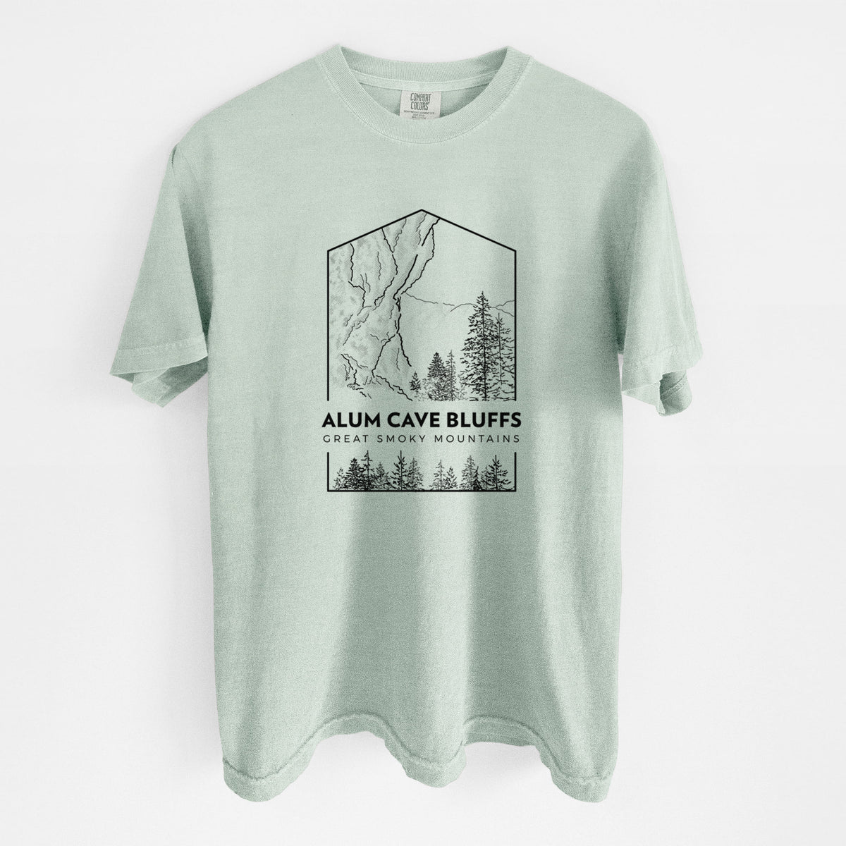 Bay green Comfort Colors t-shirt laid flat, printed with a black line art badge of Alum Cave Bluffs with pine trees, with the words Alum Cave Bluffs, Great Smoky Mountains.