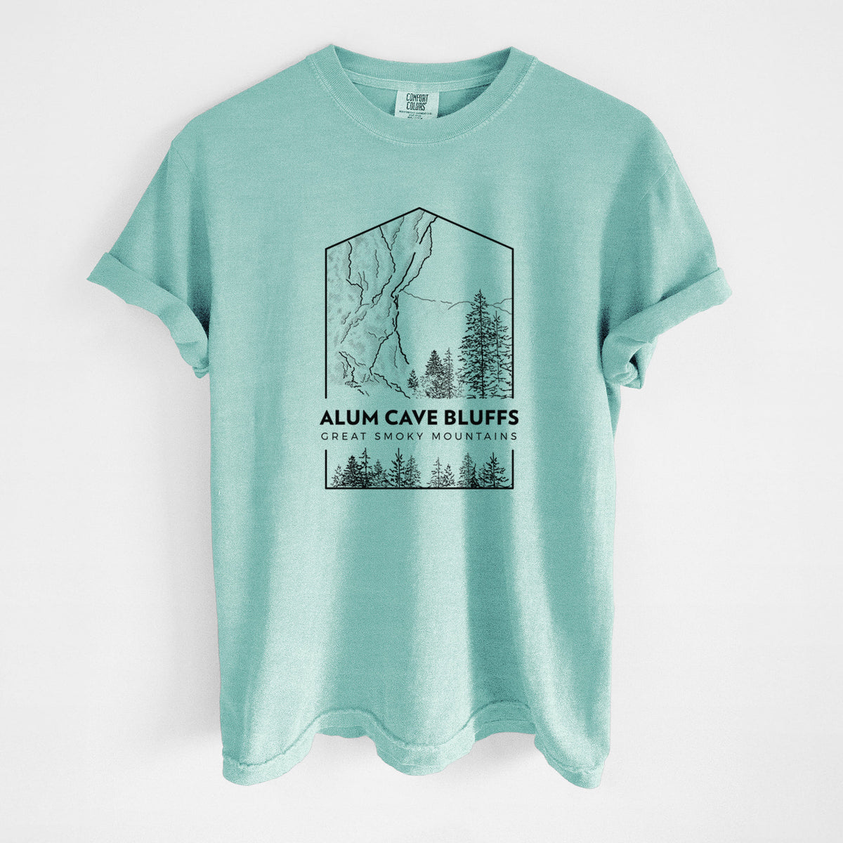 Chalky mint Comfort Colors t-shirt laid flat, printed with a black line art badge of Alum Cave Bluffs with pine trees, with the words Alum Cave Bluffs, Great Smoky Mountains.