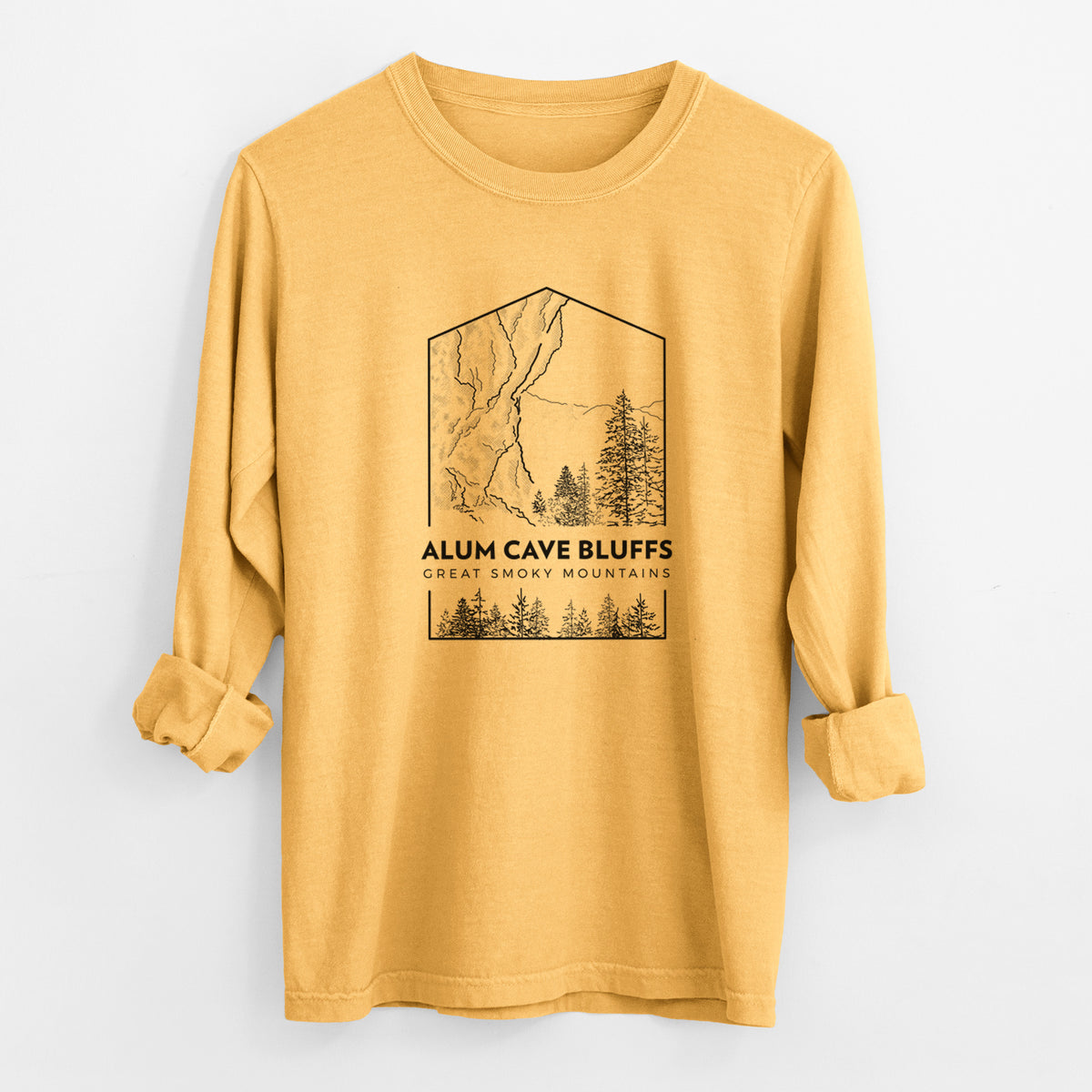 Golden wheat yellow Comfort Colors long sleeve shirt laid flat with the cuffs rolled, printed with a black line art badge of Alum Cave Bluffs with pine trees, with the words Alum Cave Bluffs, Great Smoky Mountains.