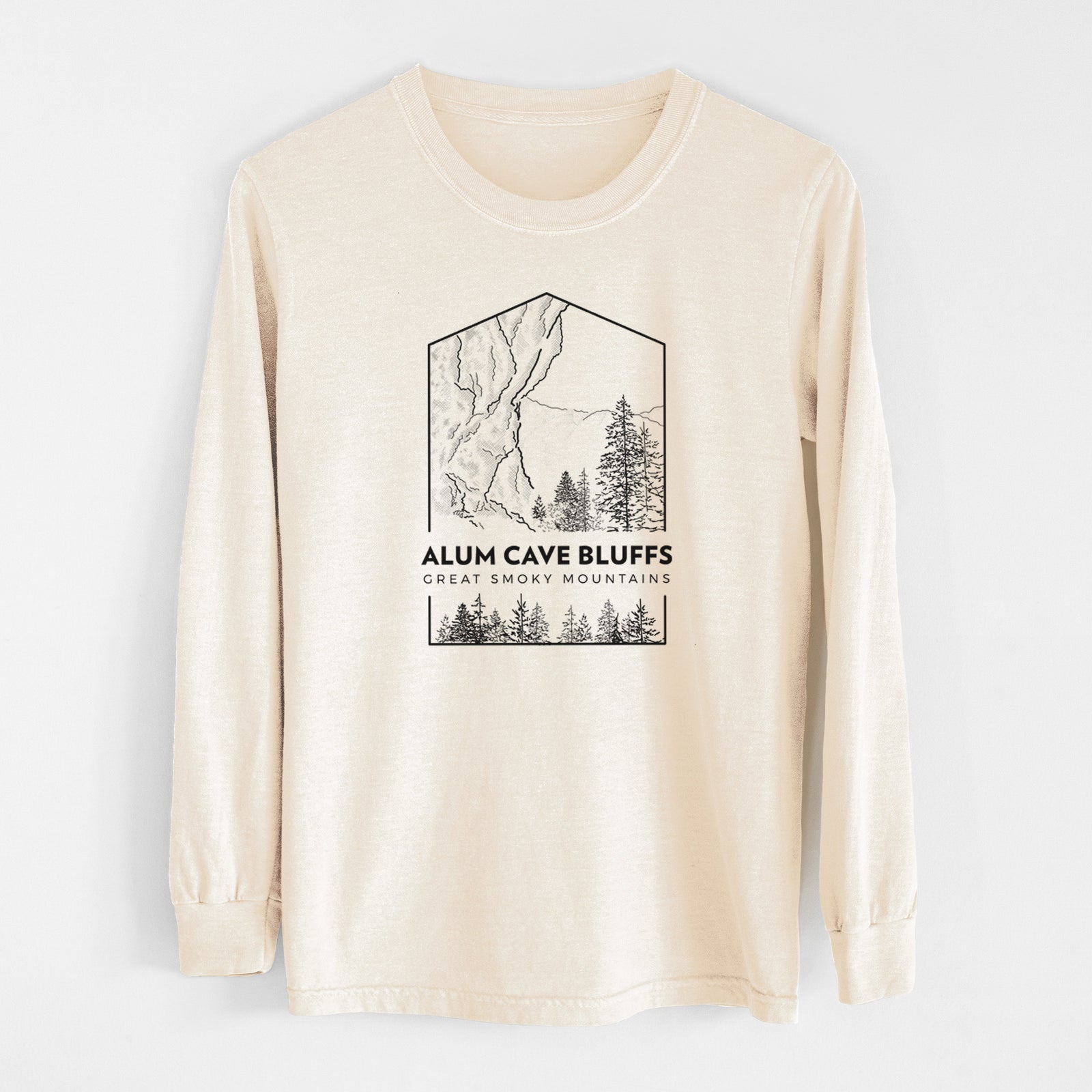 Ivory Comfort Colors long sleeve shirt laid flat, printed with a black line art badge of Alum Cave Bluffs with pine trees, with the words Alum Cave Bluffs, Great Smoky Mountains.