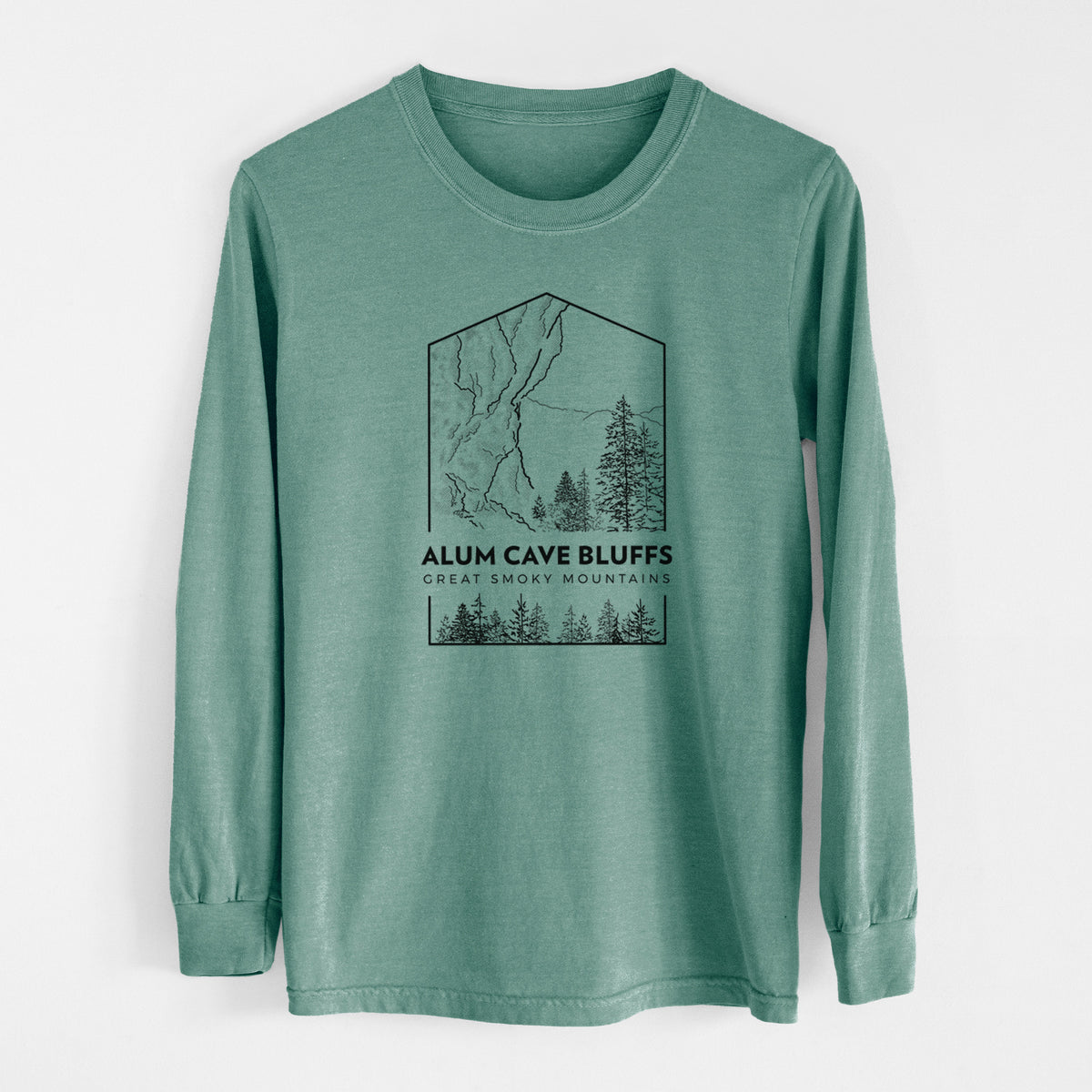 Pine green Comfort Colors long sleeve shirt laid flat, printed with a black line art badge of Alum Cave Bluffs with pine trees, with the words Alum Cave Bluffs, Great Smoky Mountains.