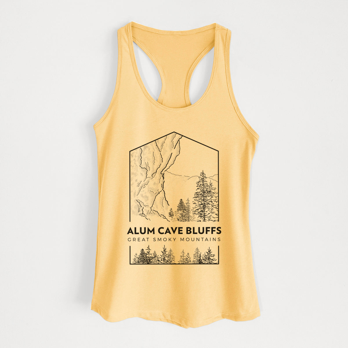 Banana cream women's racerback tank top laid flat, printed with a black line art badge of Alum Cave Bluffs with pine trees, with the words Alum Cave Bluffs, Great Smoky Mountains.